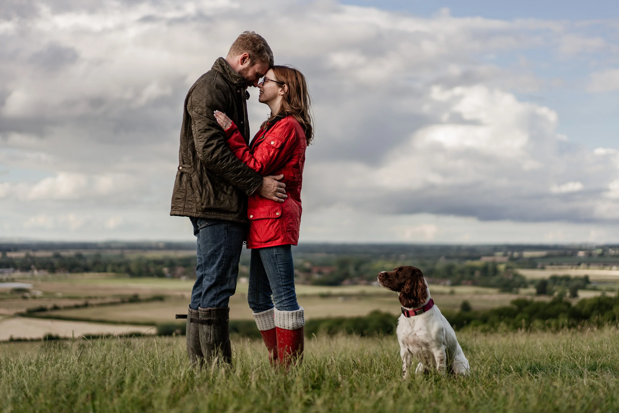 Close-up of a man in a blue suit with a pink tie and boutonniere
