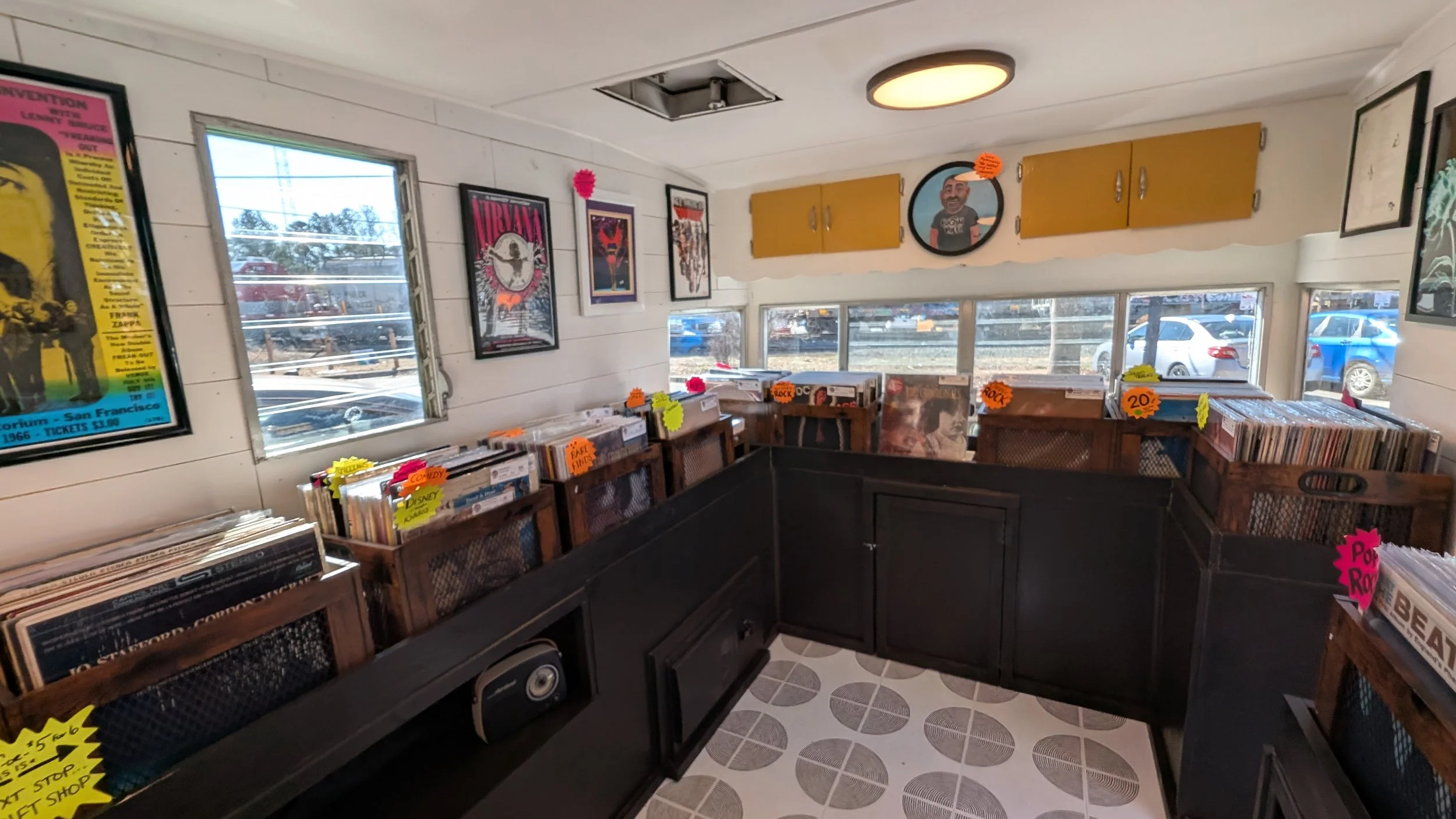 Keeping old charm. Adding modern circle flooring, black shelving, artwork, lighting