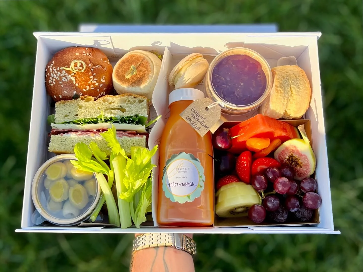 Modern afternoon tea - carrot and turmeric juice, loaded focaccia, coronation chicken roll, brunch muffin, crudit&eacute;s, all butter scone, vanilla bean and white chocolate macaron and fresh fruit 
#catering #box #aviation #privatejet