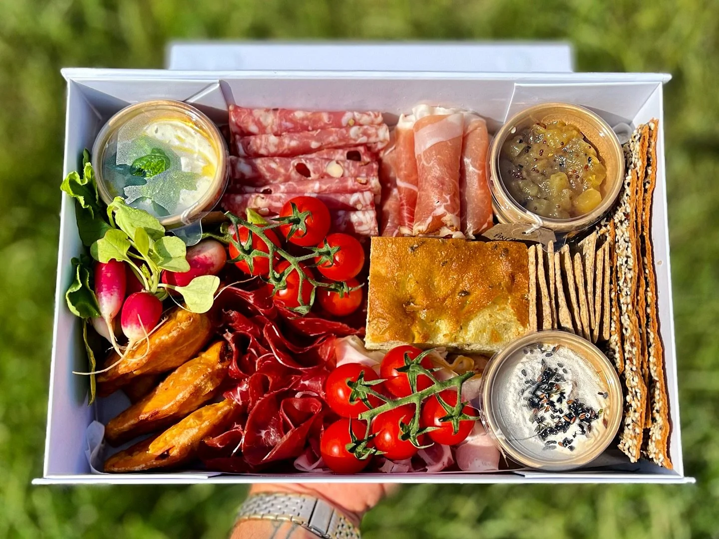 Afternoon grazing - 
chorizo empanadas, hazelnut salami, parma ham, bresola, wild garlic focaccia, crackers, and selection of chutneys and dips (pineapple core chutney, butter bean houmous, labneh) with radish and on the vine tomatoes