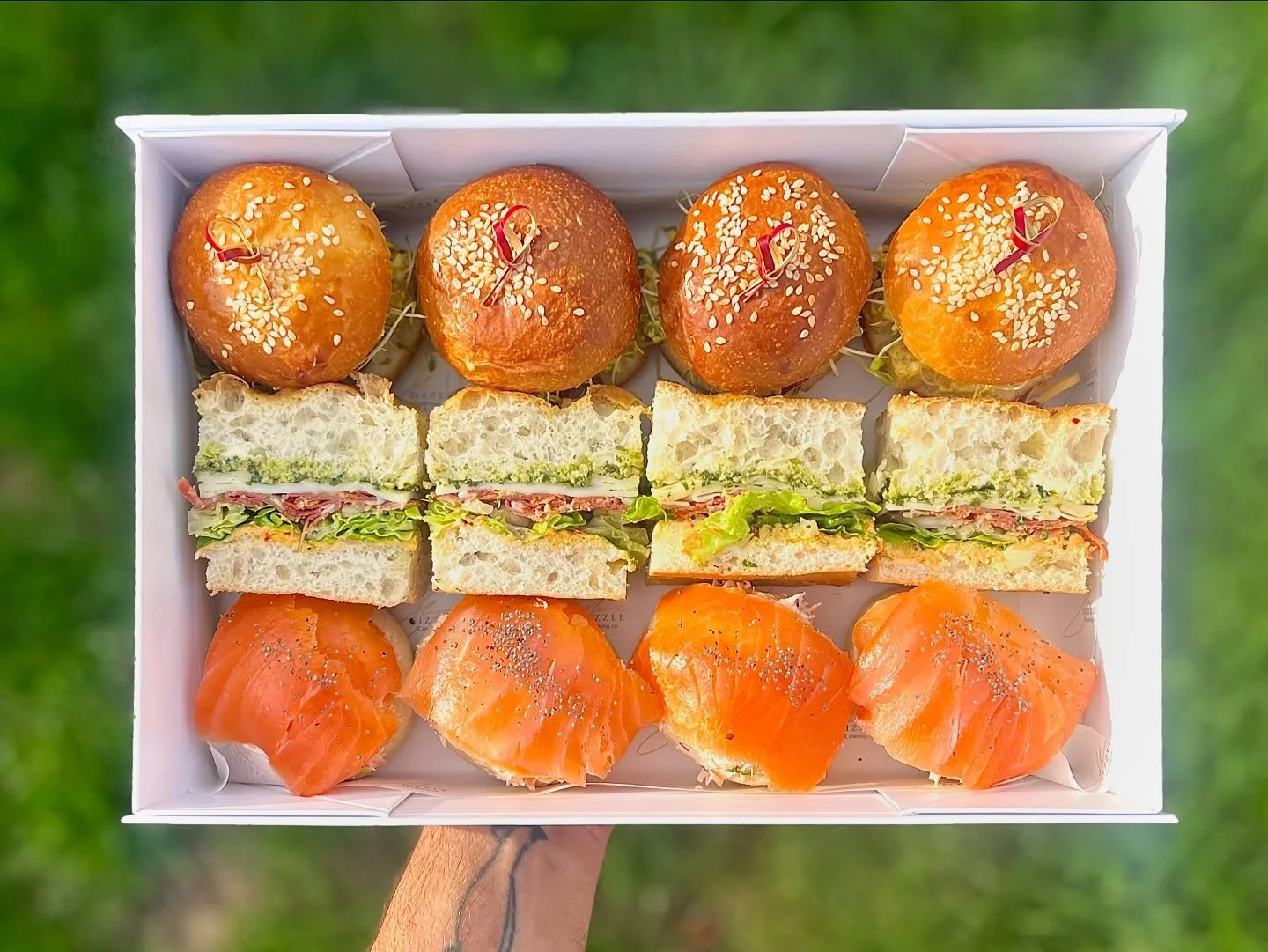 It&rsquo;s not just a coincidence everything fits in there perfectly!
We make our own focaccia, bread rolls and English muffins to fit our boxes, so they&rsquo;re nice and snug.
Our current go-to features coronation chicken rolls, poached salmon, cre