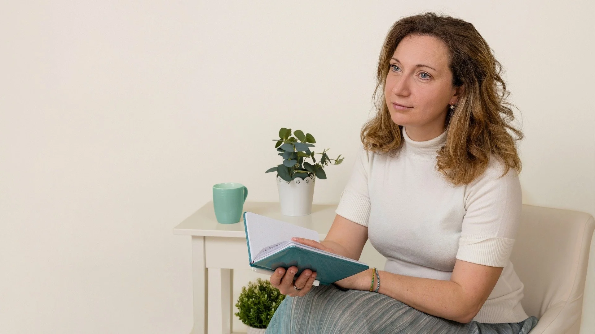 Professional in a reflective, approachable setting. Visibility mindset for personal branding — overcoming imposter syndrome for established experts