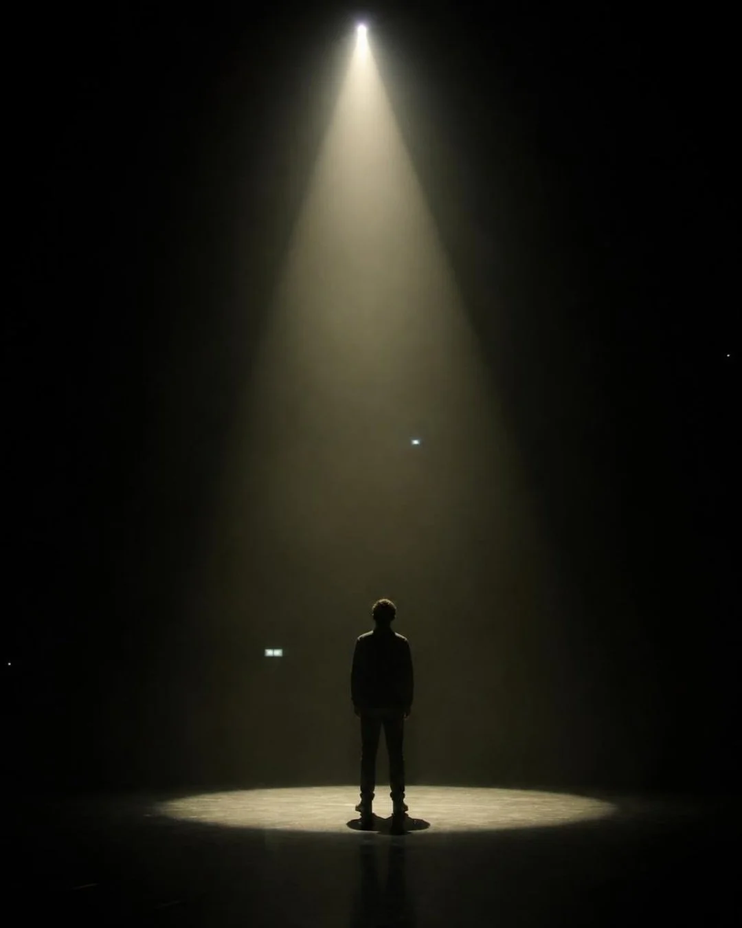 Dark image in the spotlight. Fear of online visibility for established experts and personal brand exposure
