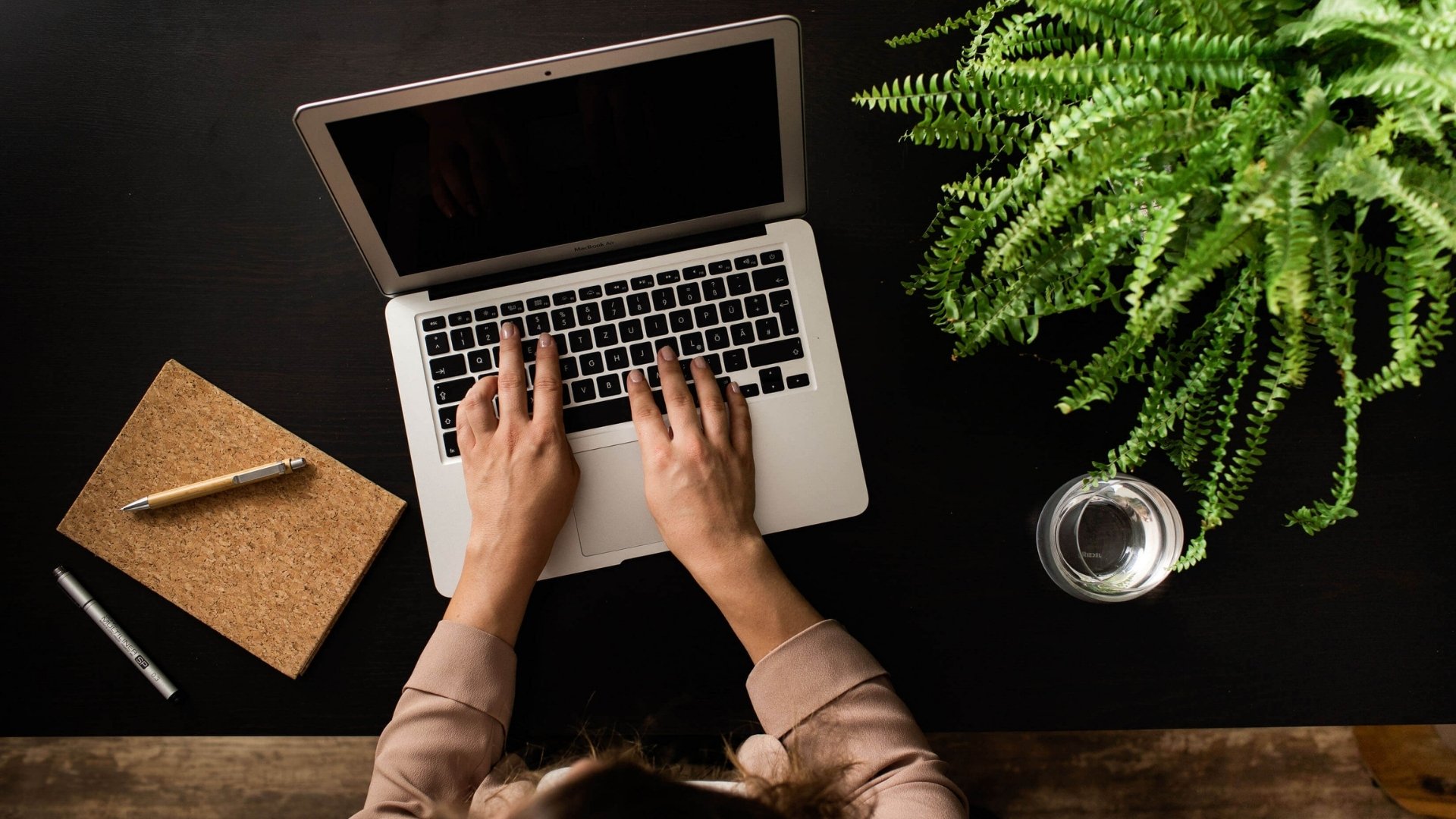 Hands over keyboard, hesitant. Perfectionism blocking expert content creation and personal brand visibility