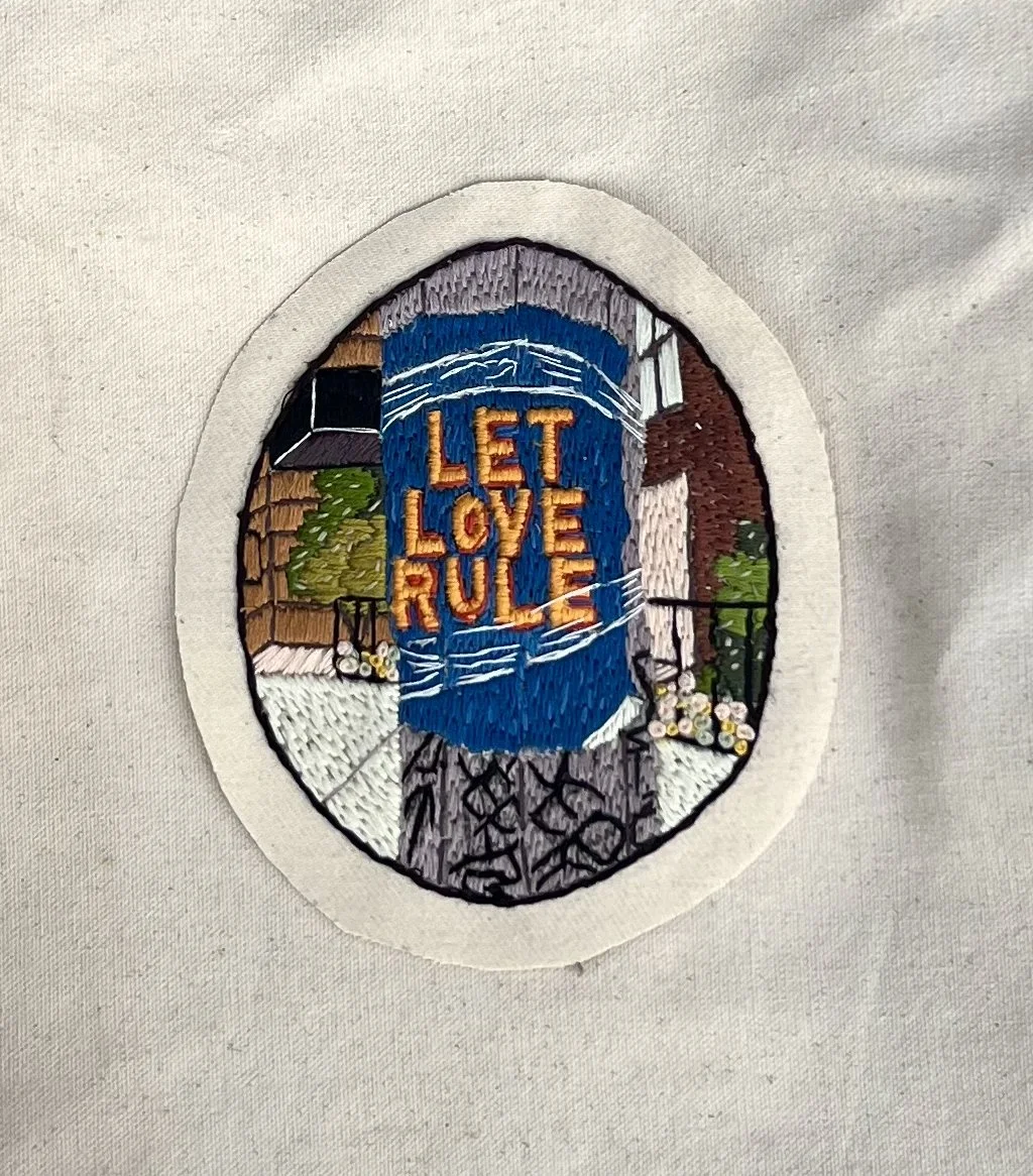 Let Love rule hand-embroidered patch stitched on artist canvas, designed to be worn, collected, and carried as a declaration of love.