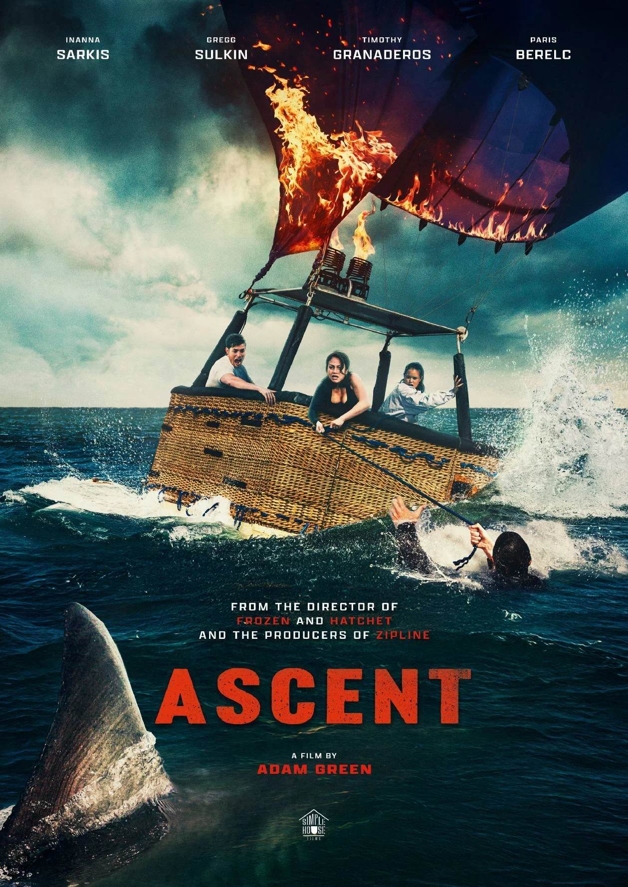 A scene from the movie 'Ascent' showing a hot air balloon with flames, sinking in the ocean with three people inside, and a shark approaching from below, with a swimmer in the water.