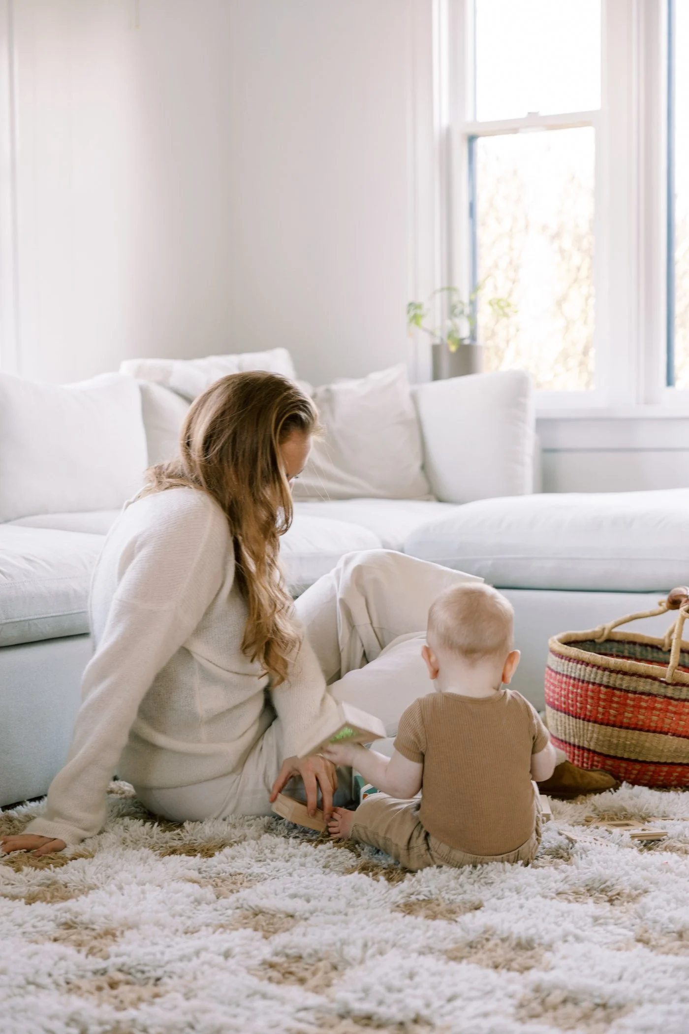 Happy first time mother playing with baby