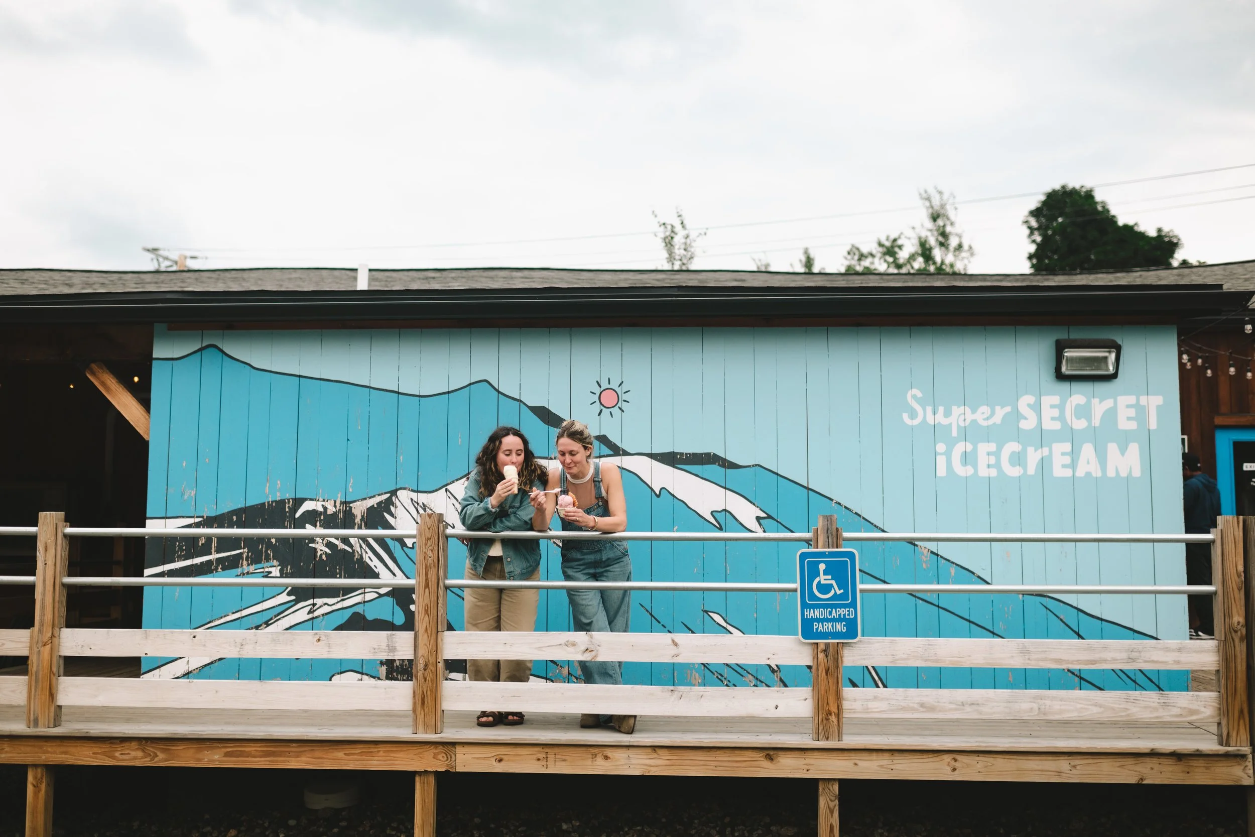 lesbian couple ice cream date queer engagement session Super Secret Ice Cream Gorham New Hampshire couples photography candid date night photos documentary engagement photography wlw queer new england vermont photographher weddings