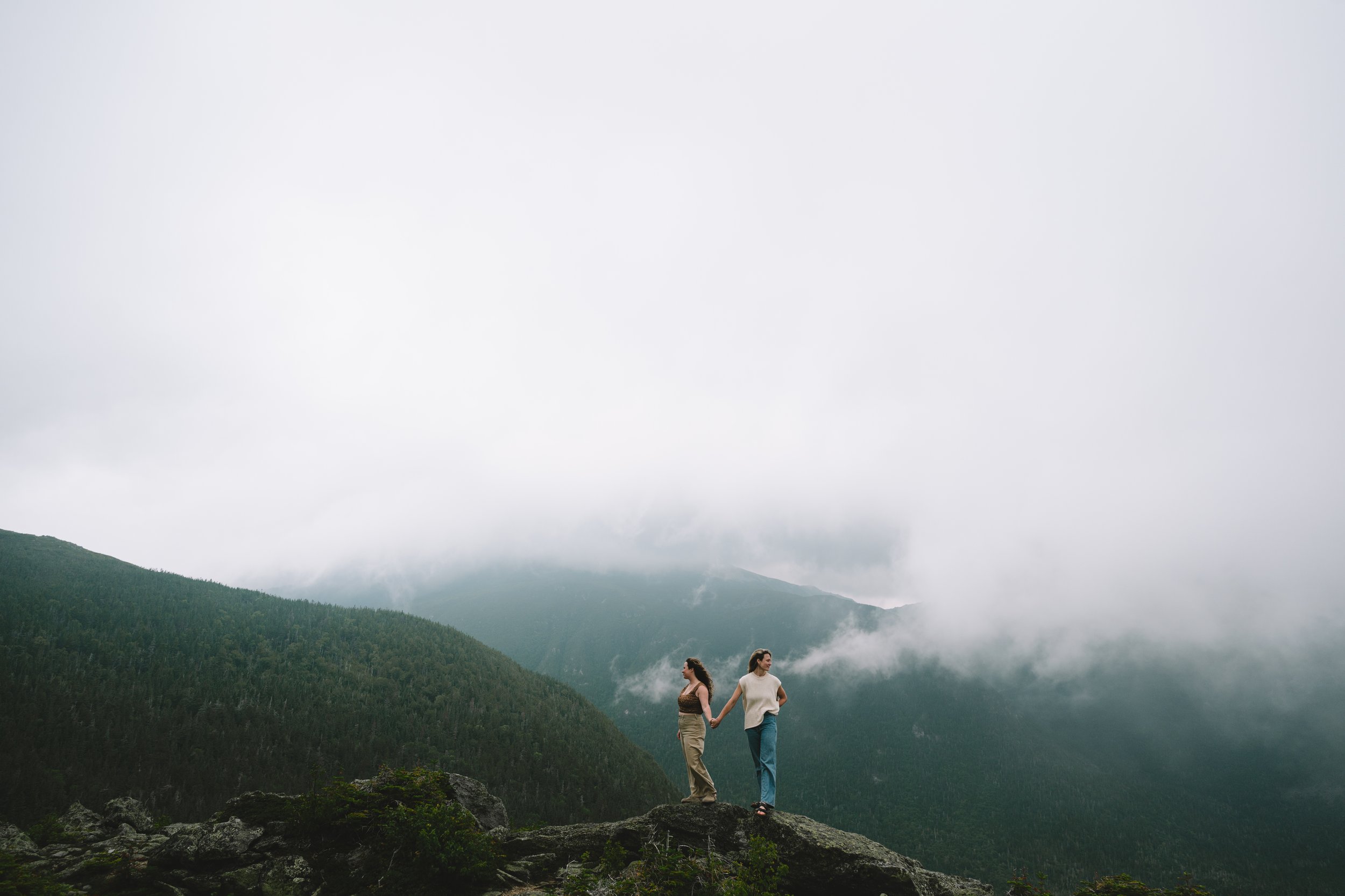mountain engagement session adventure engagement photos hiking engagement session outdoor couples photography rocky mountain photos foggy mountain engagement photos cinematic engagement photography wlw queer photographer lesbian engagement session
