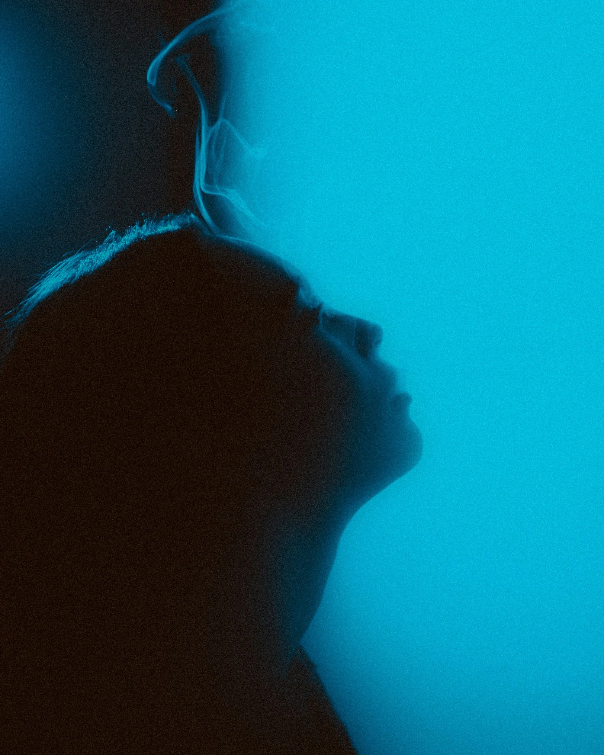 individual with eyes closed and smoke