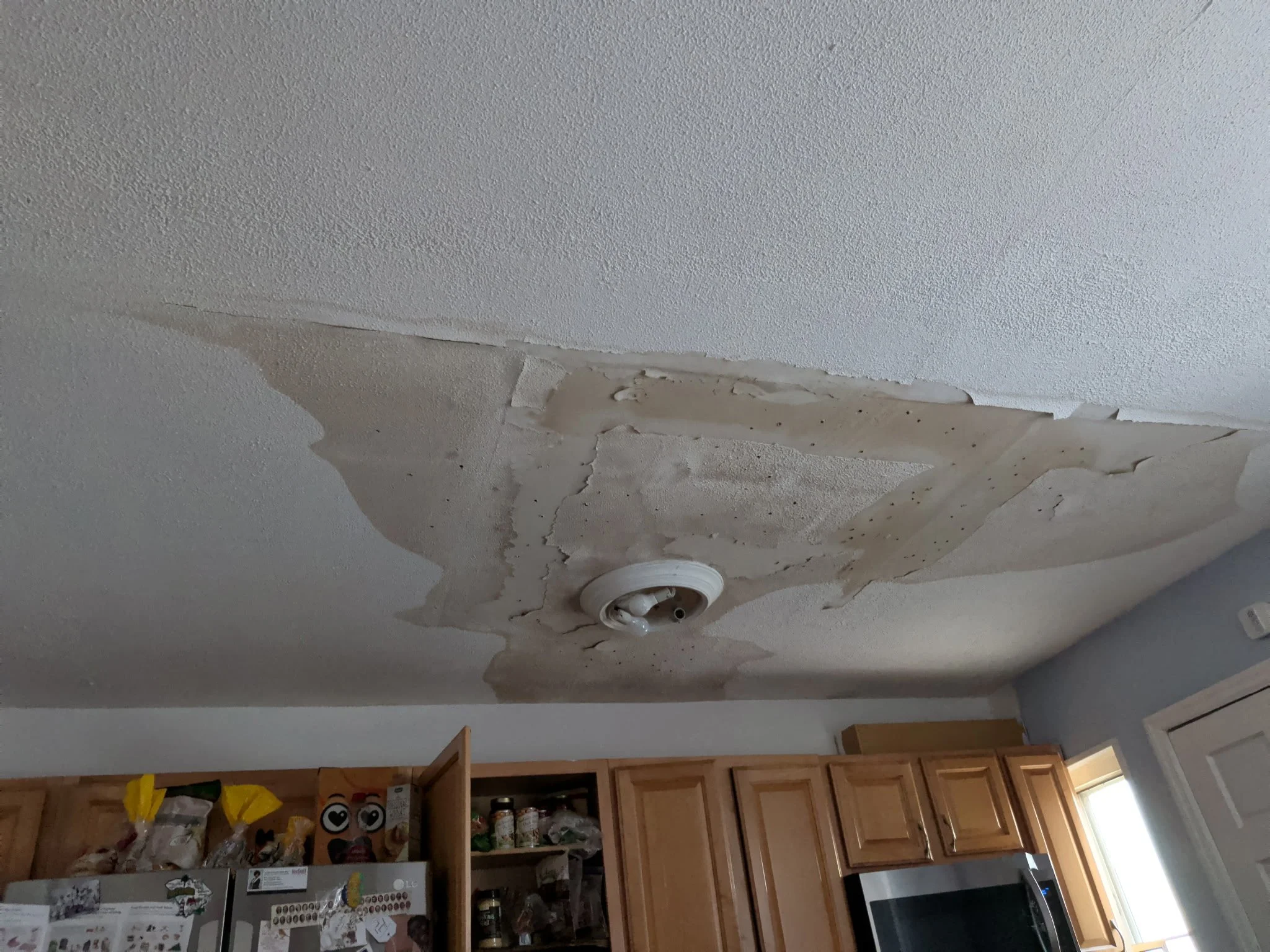 Water damaged ceiling with peeling paint and staining — moisture testing NYC