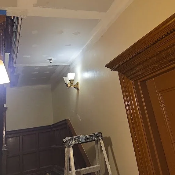 Ceiling drywall installation in Miami apartment building common area hallway