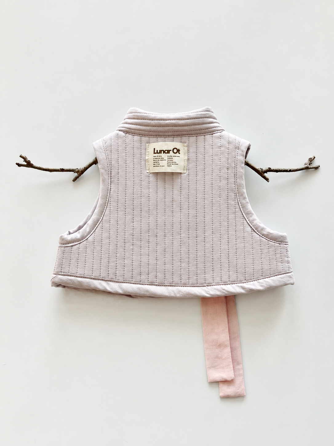 Blush Quilted Vest with Twig Hanger.png