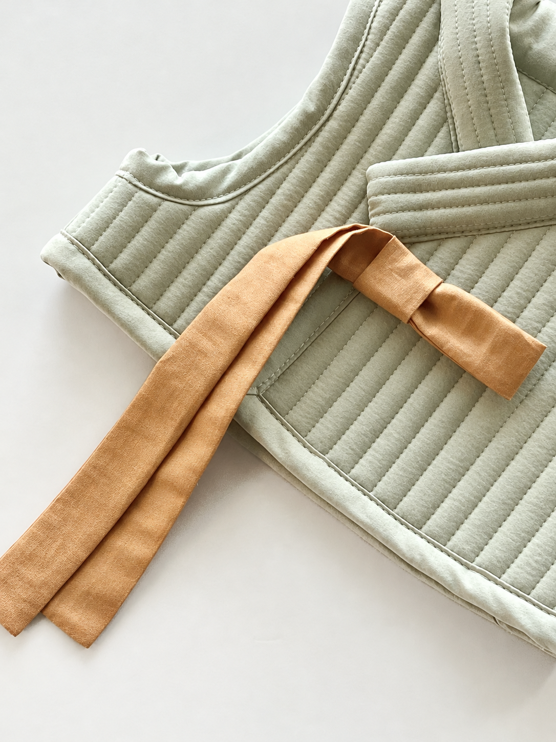 Pale Sage Quilted Vest with Tan Tie.png