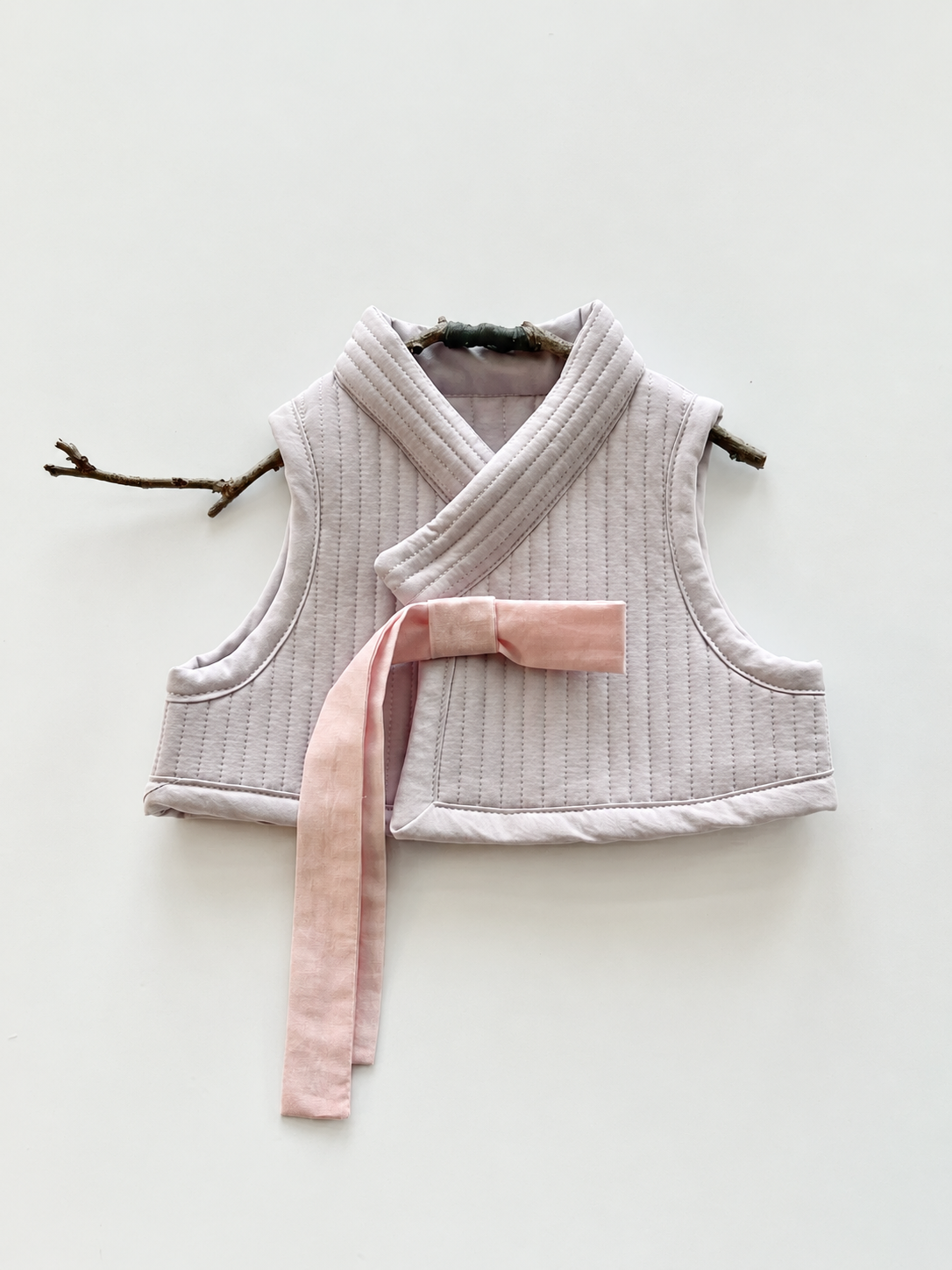 Quilted Lavender Baby Vest with Pink Tie.png