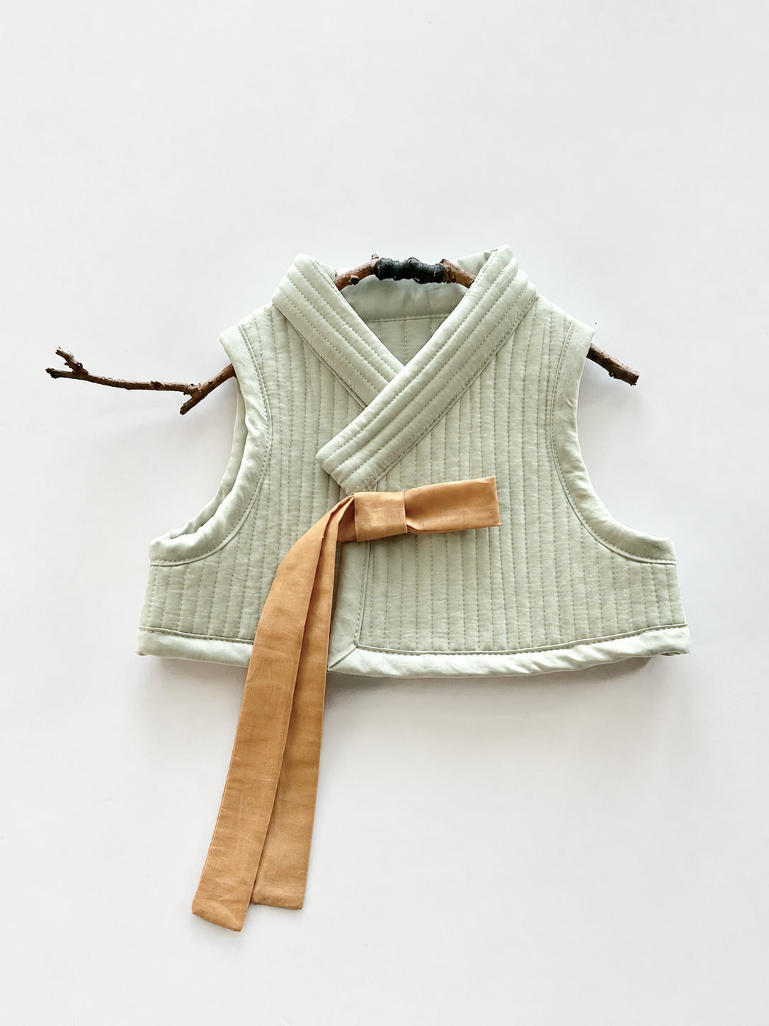 Pale Mint Quilted Vest on Twig Hanger.png