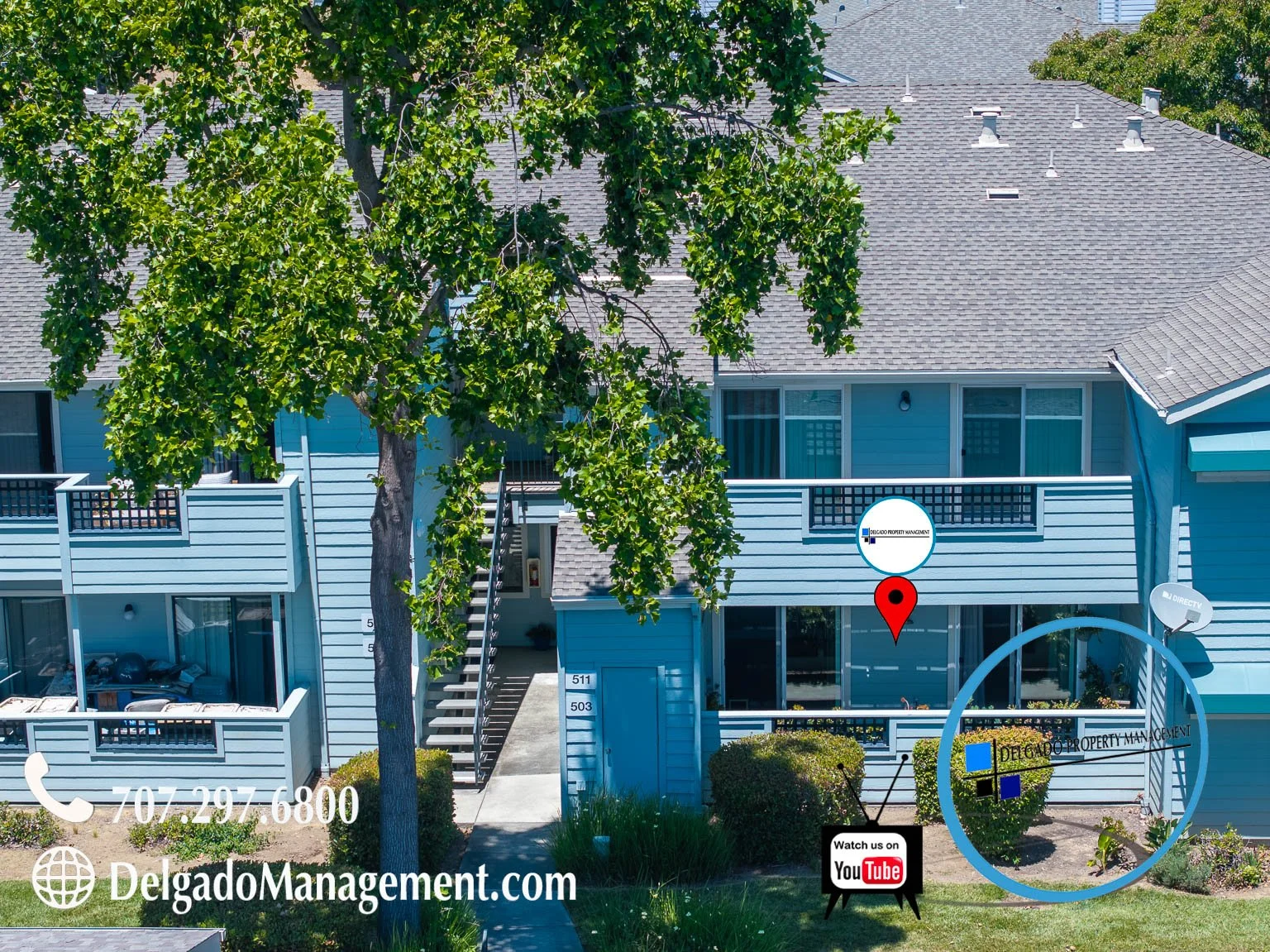 A two-story blue residential building with balcony, adjacent to a sidewalk with bushes, trees, satellite dish, and signage for Delgado Property Management, including contact information and a YouTube icon.