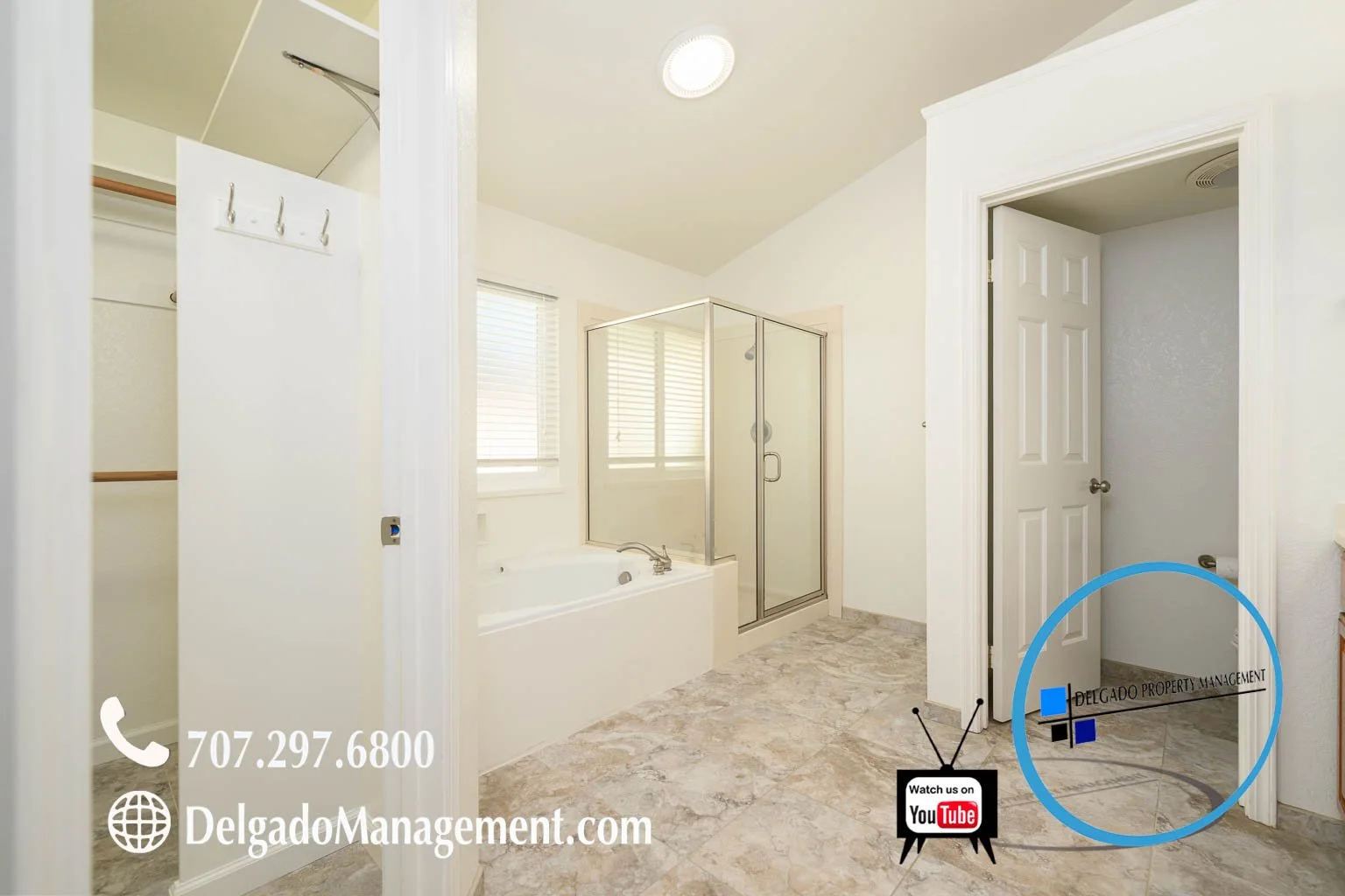 Bathroom with bathtub, shower stall, two windows with blinds, and open closet with hanging rods. Text overlay includes phone number, website, and property management company's logo.
