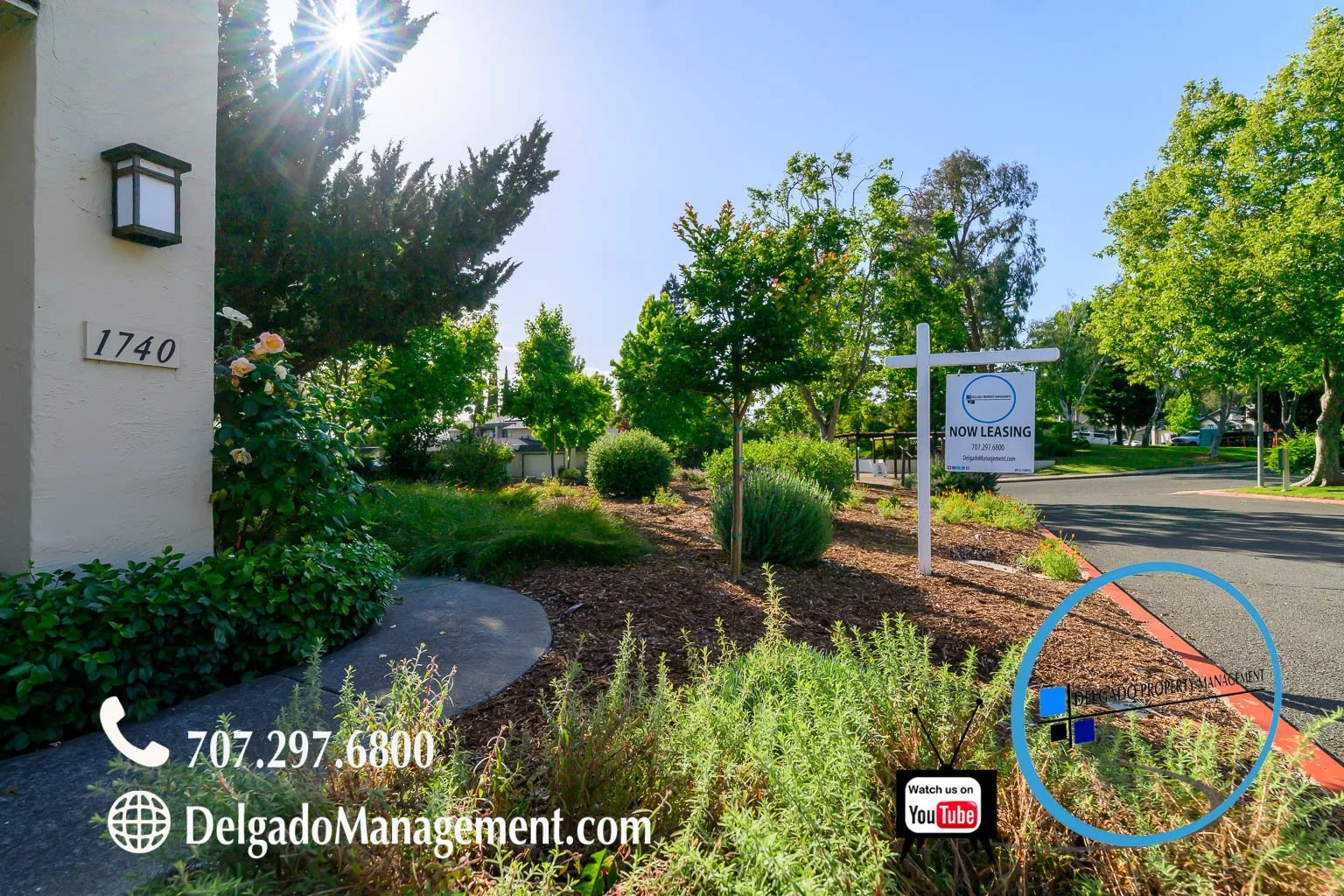 Exterior view of a property with a white building number 1740, landscaped garden with bushes and trees, now leasing sign, and a sidewalk. Contact information and website for Delgado Management are displayed at the bottom, along with a YouTube icon.