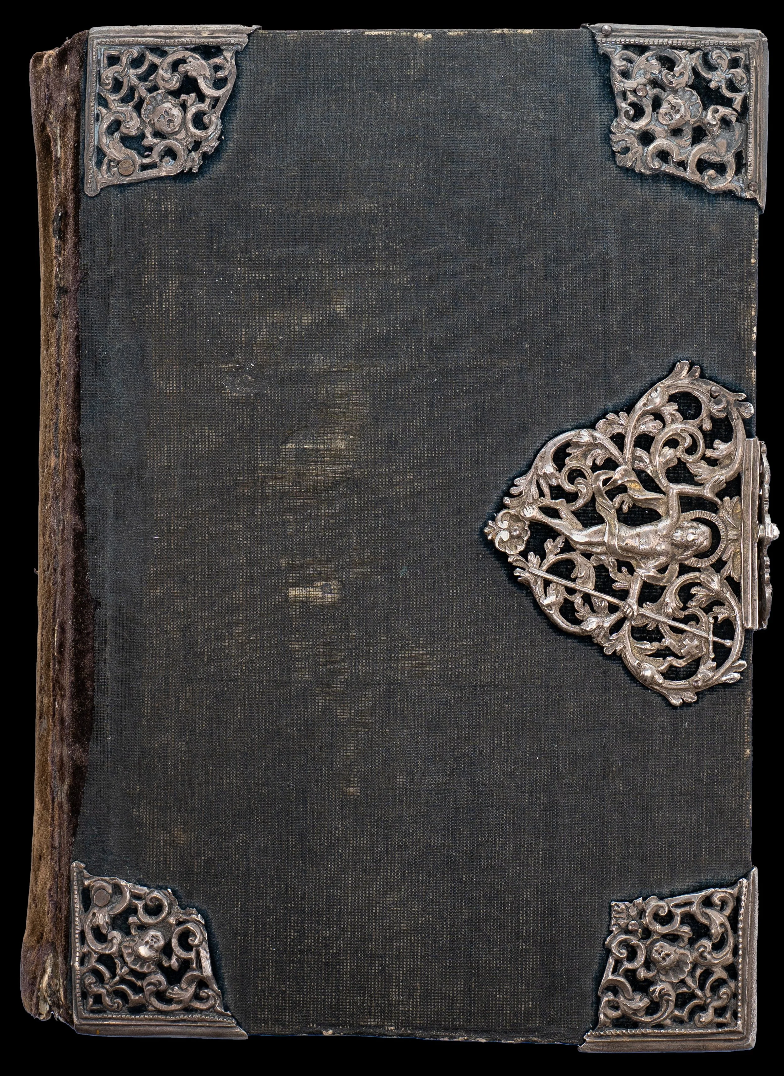 Eighteenth century black velvet binding with silver fittings enclosing the fifteenth-century Bruges Book of Hours