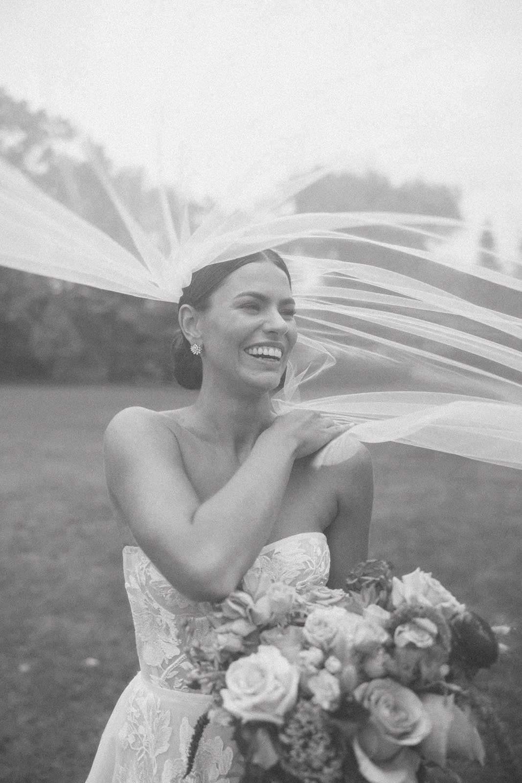 candid bride moment in her veil