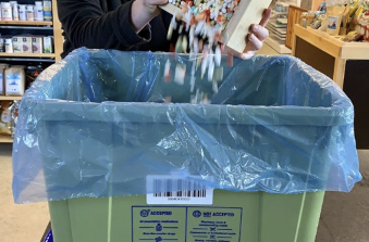 Medication disposal bin lined with a plastic bag