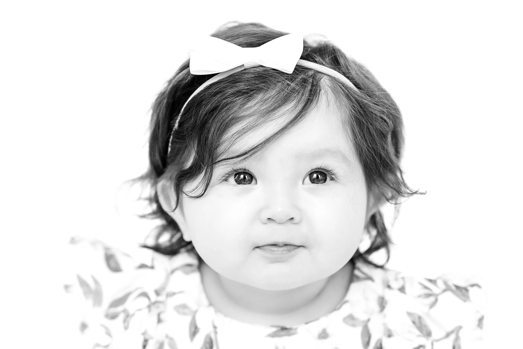 Black and white portrait of a baby with a headband