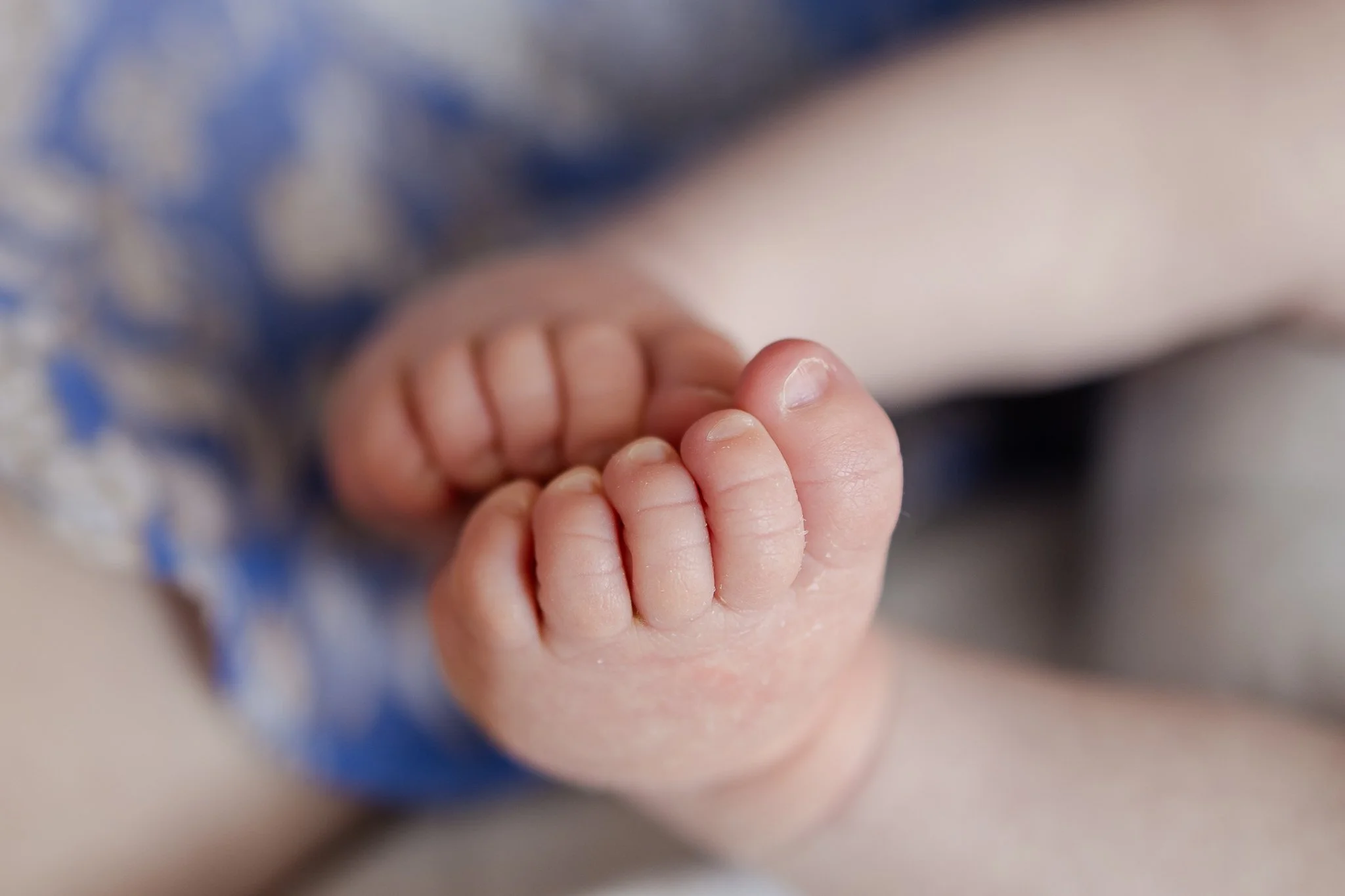 Close-up of a baby's feet with curled toes.