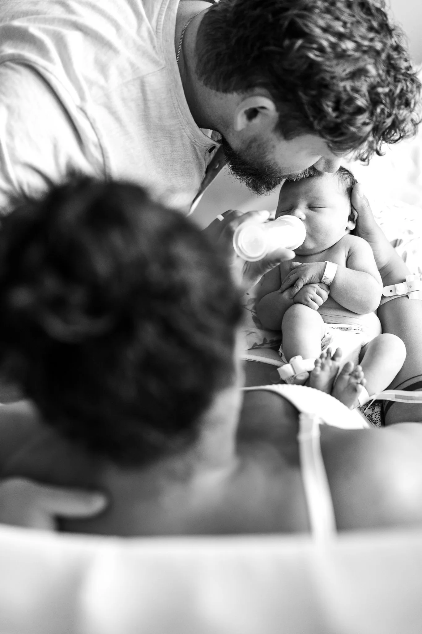 dad kissing baby's head after birth in memphis tn hospital 