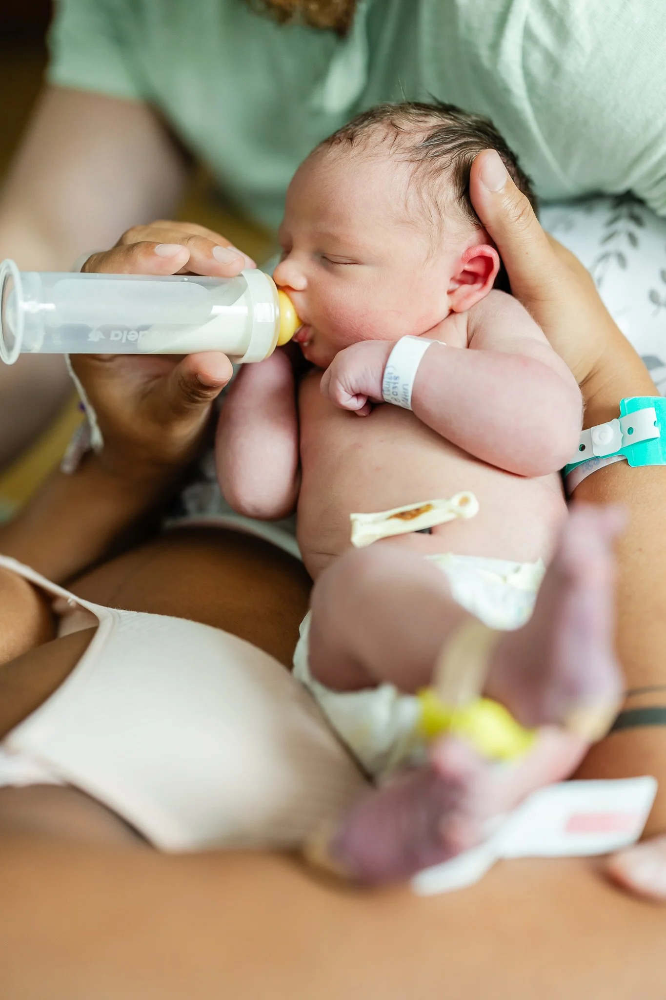 baby being fed a bottle by new parents after birth in memphis tn hospital 