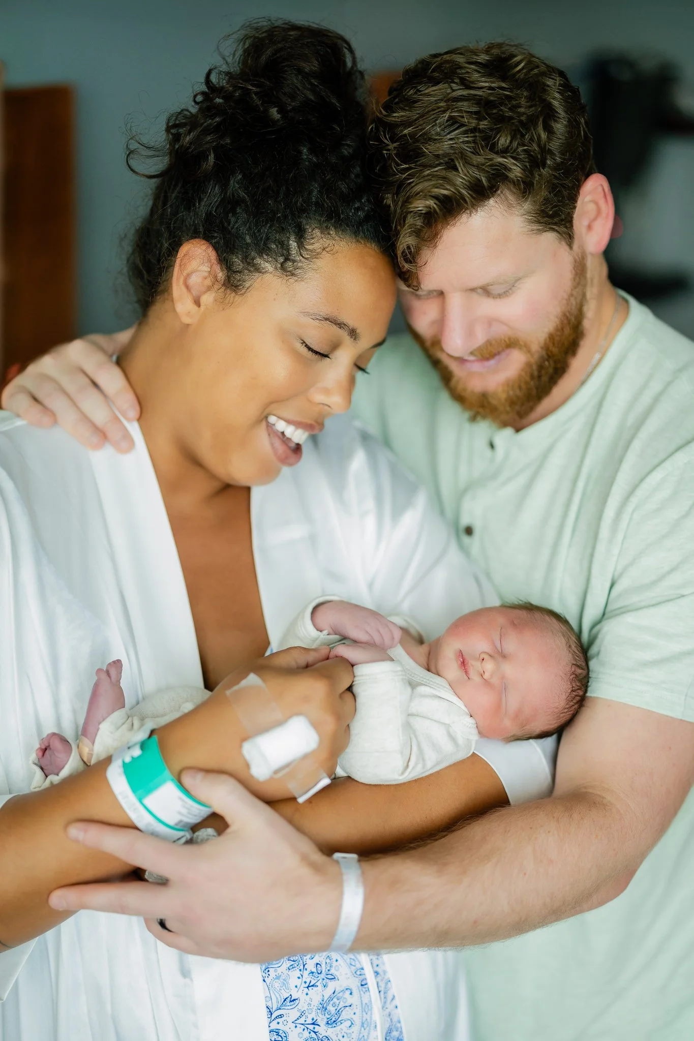 mom and dad snuggling their newborn son in memphis tn right after birth