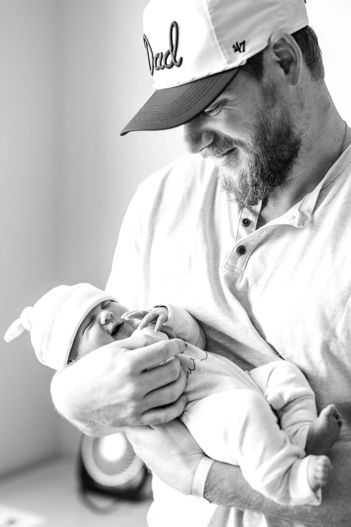 brand new dad holding his newborn son