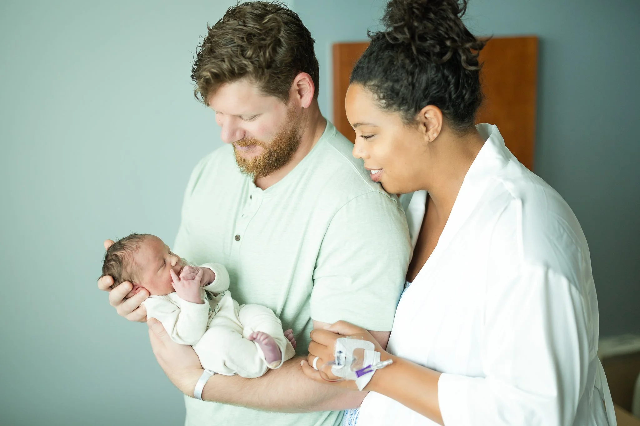 mom and dad admiring their newborn son right after birth in memphis