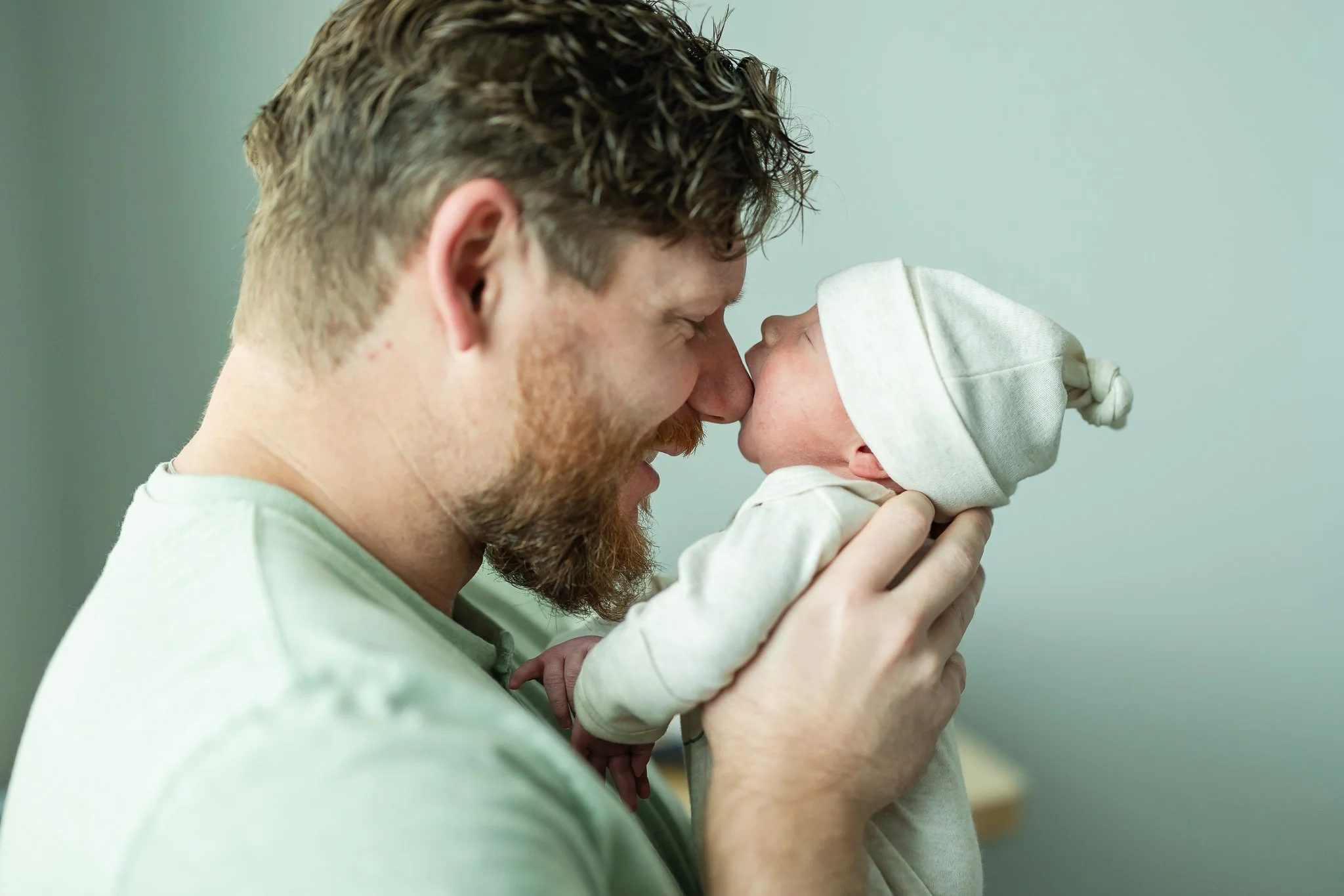 newborn baby boy sucking on dads nose