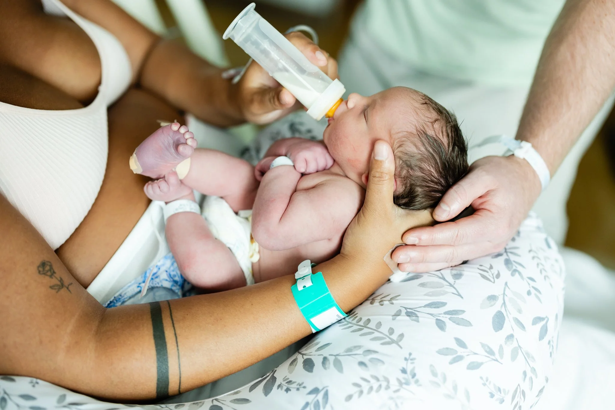baby being fed a bottle by new parents after birth in memphis tn hospital 