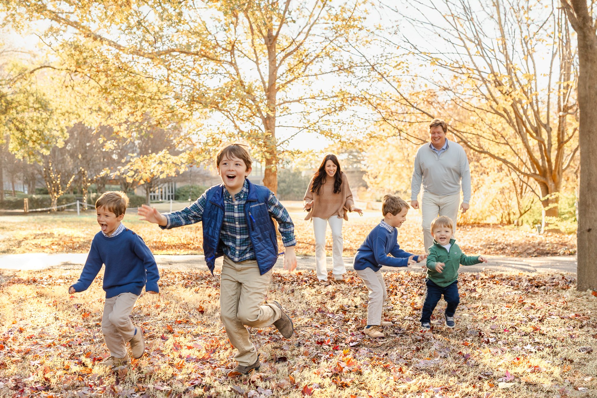 family playing in fall leaves during Family Photography using Natural Light by Caitlin Ross in Memphis Tennessee