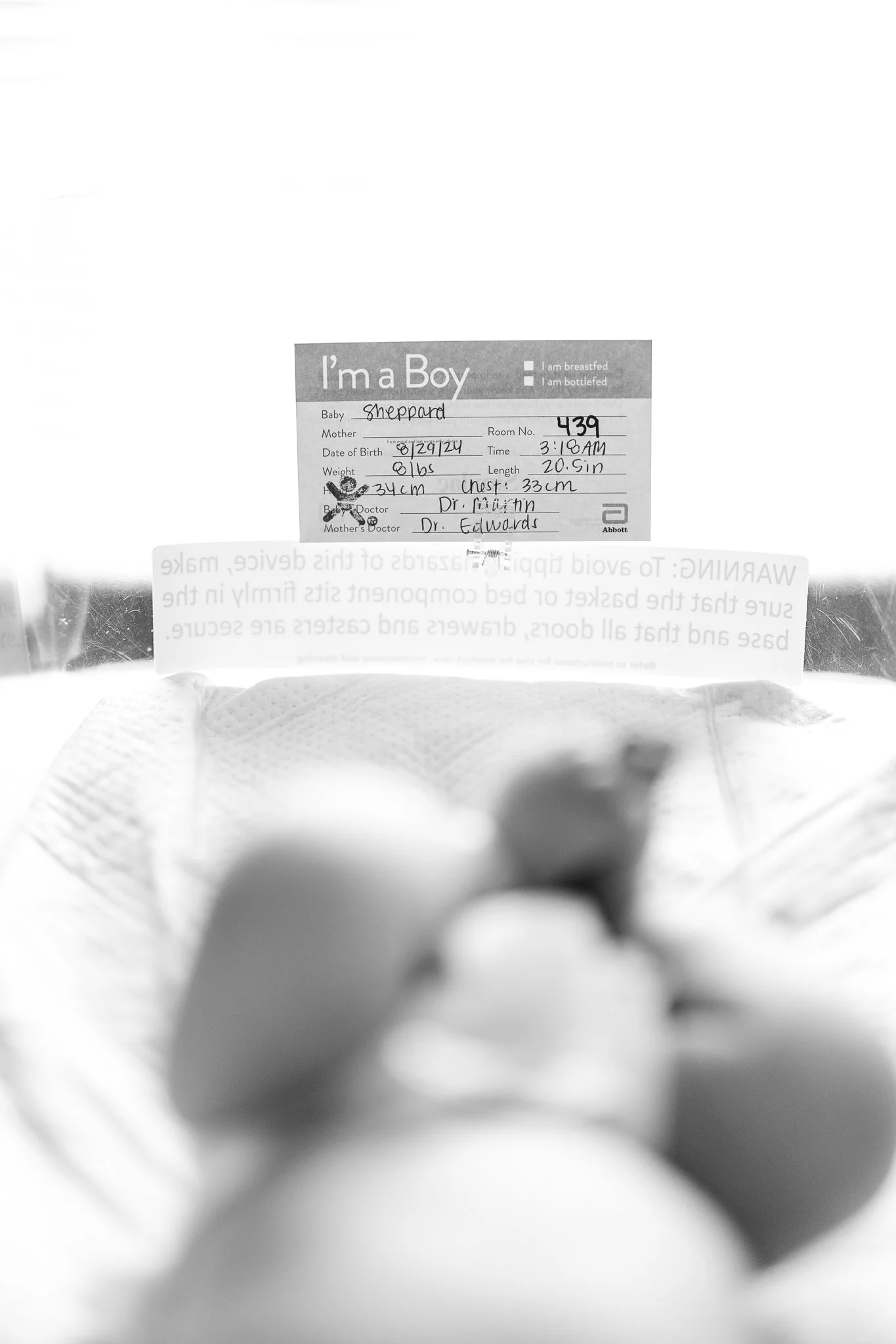 newborn tag in hospital bassinet 