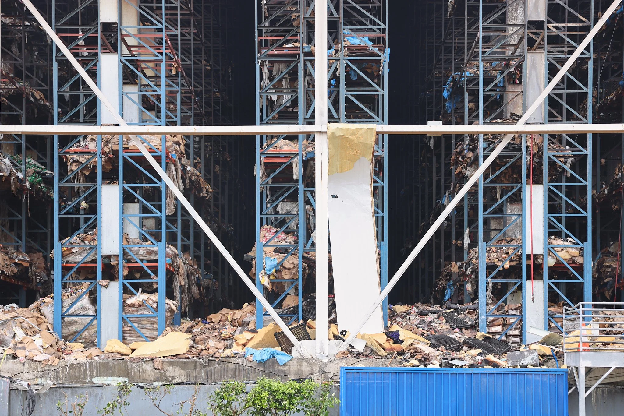 At the end of La Puerta St., a view of the food storage warehouse, in ruins two weeks after the fire, on July 2, 2026, in Los Angeles, CA. Much of the exposed meat and flesh thawed without power, rotting into a foul-smelling, putrid slush that has co