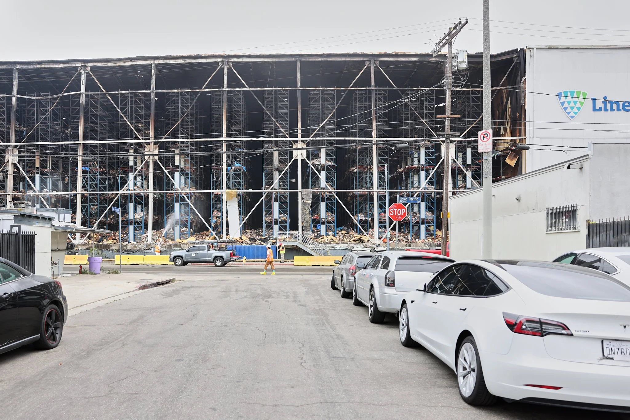 Charred remains of the Lineage Logistics cold storage facility in Los Angeles, California, on July 2, 2026. The large building contained millions of pounds of frozen food that began to spoil due to structural damage.