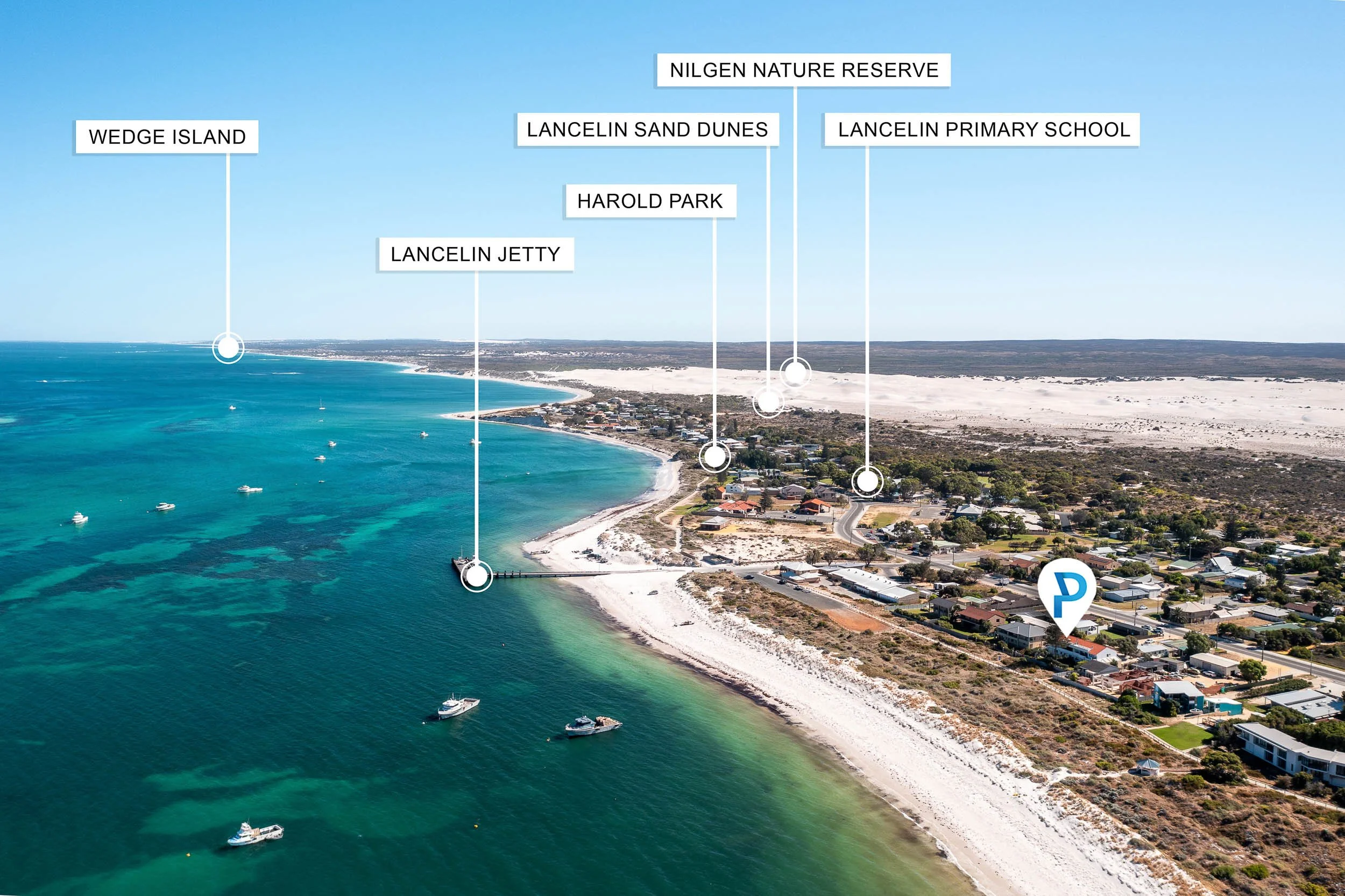 Aerial coastal view showing the beach, waterfront homes and labelled nearby landmarks.