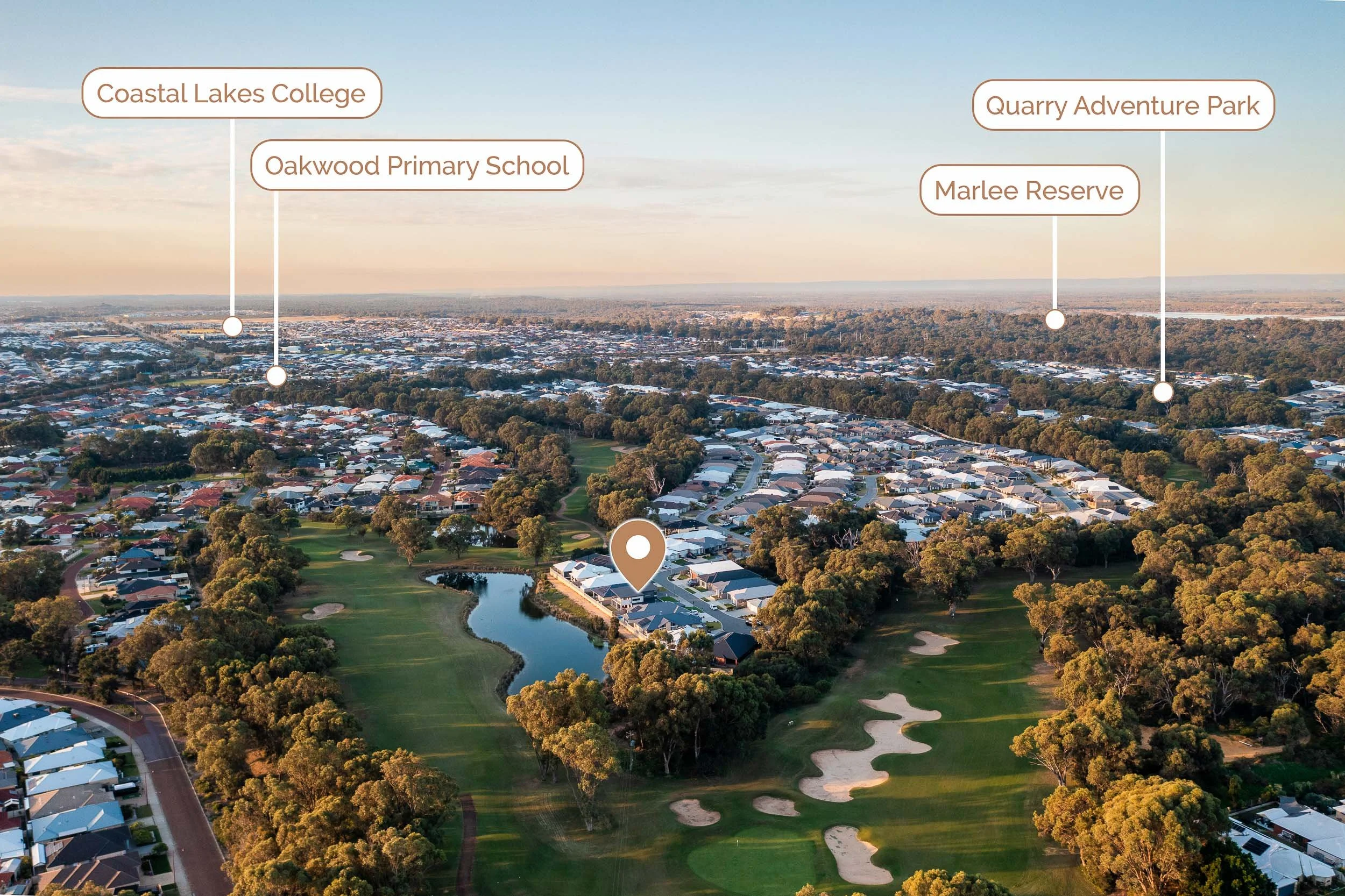 Wide aerial view of a river and surrounding neighbourhood with labelled local landmarks.