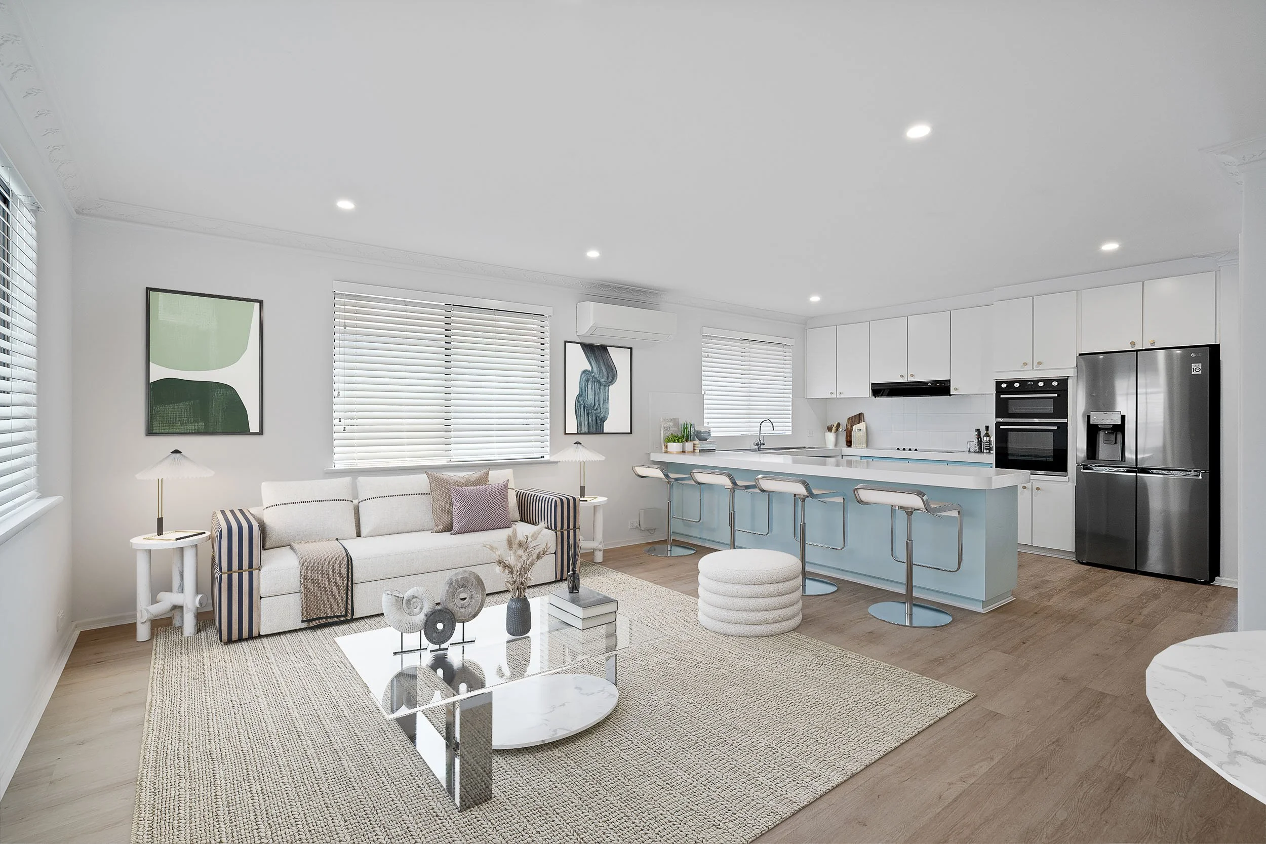 Virtual staging example with pale lounge furniture, a textured rug and an adjoining kitchen island.
