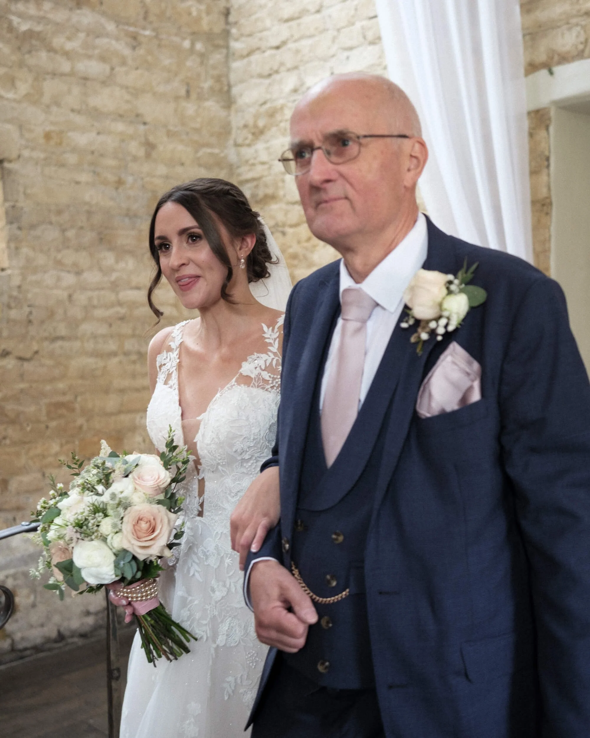 Bride walks down the aisle with her father.
