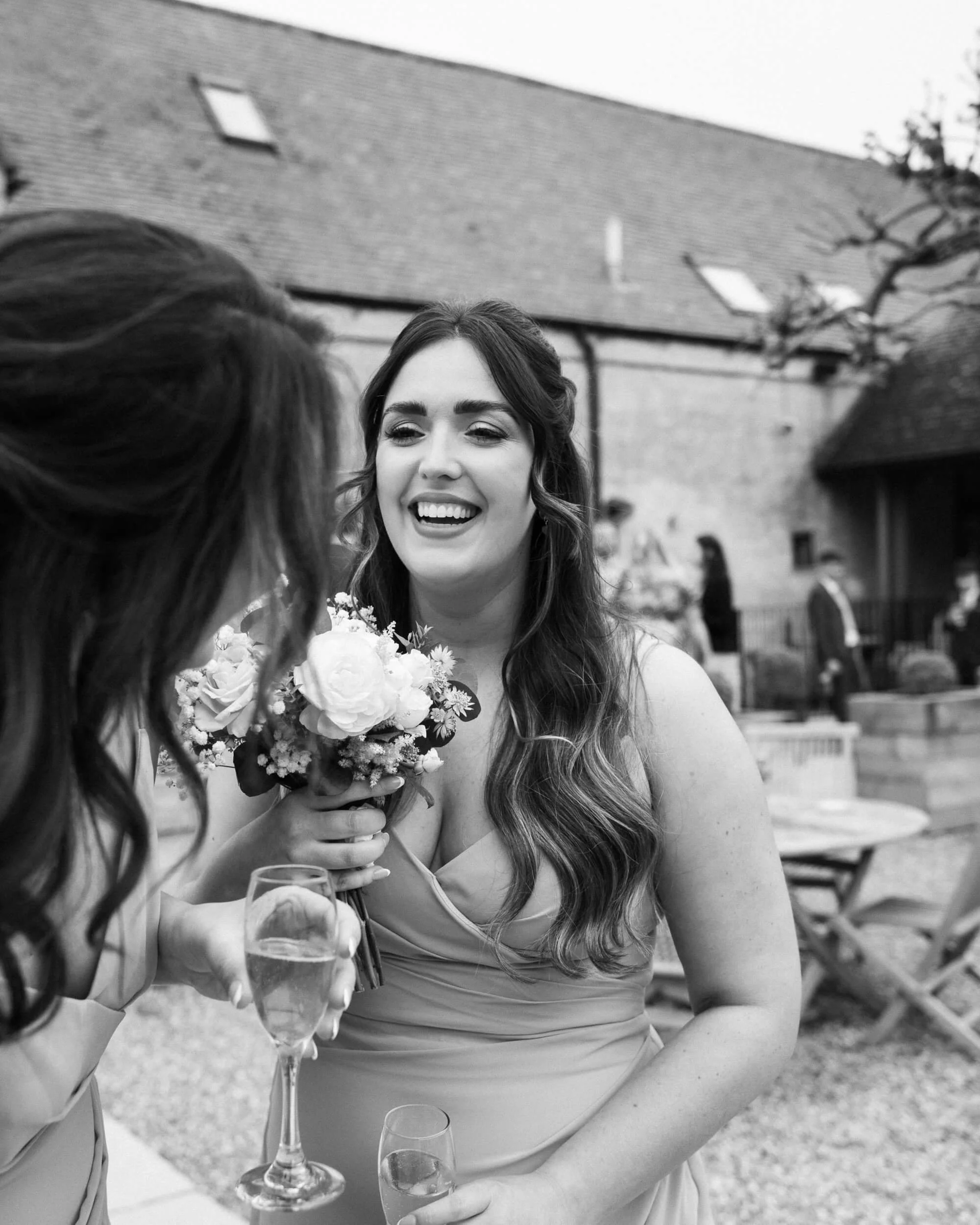 Bridesmaids laugh together at the reception in Lapstone Barn
