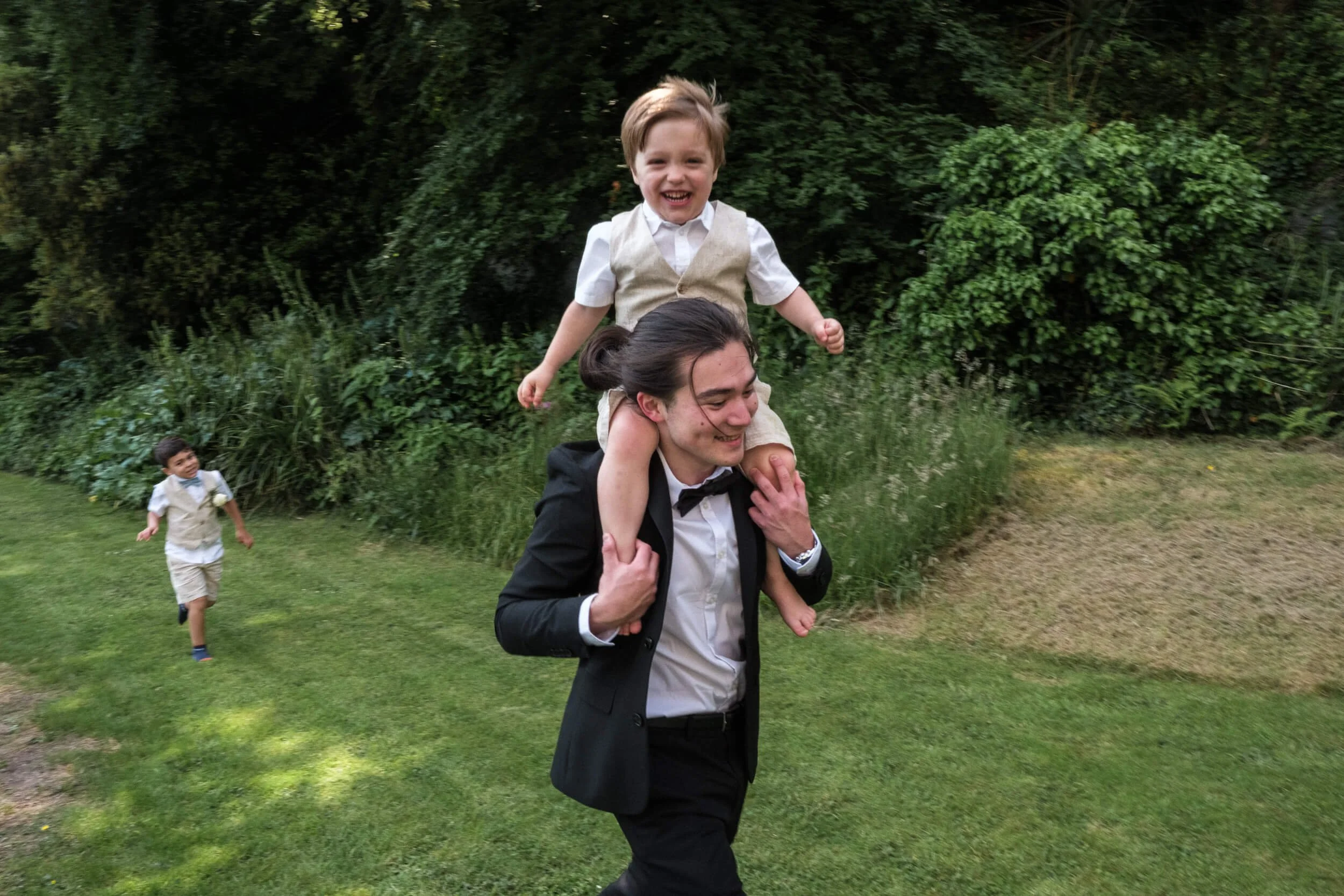 Boys run around the grounds of wedding venue Chateau Rhianfa.