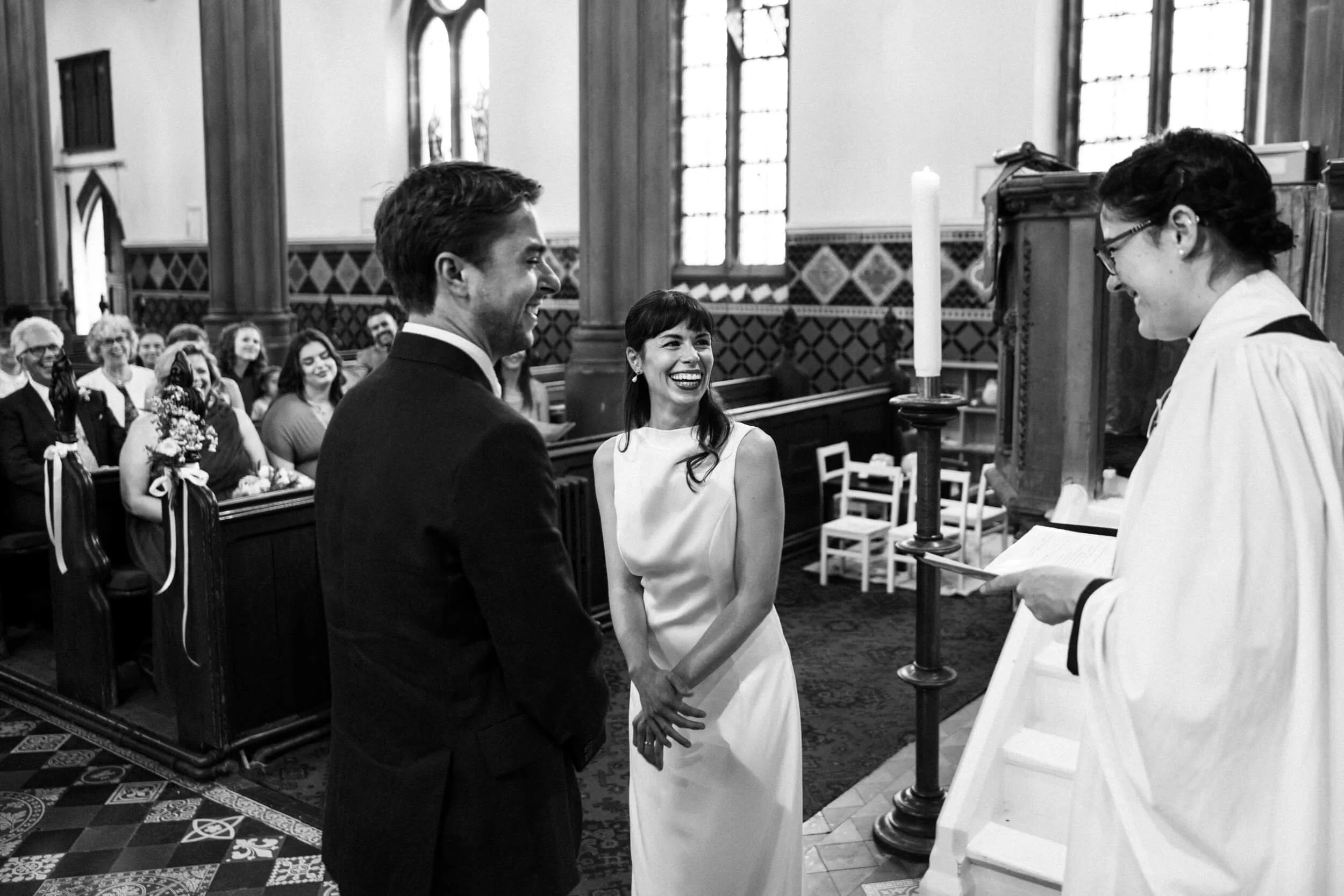 Bride and groom smile at the reverend during the ceremony