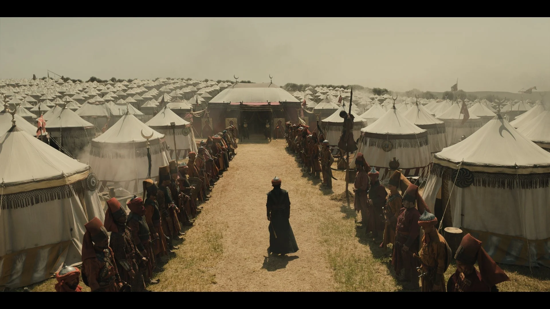 Benjamin Dino as Vladut in a sunlit military camp. A still from Rise of the Raven. Cinematography by Daniel Garas.