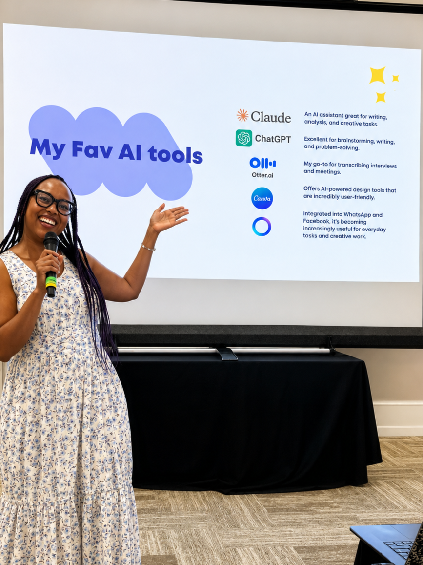 A woman with braids and glasses wearing a sleeveless dress, standing next to a presentation screen, holding a microphone, and pointing at the slide titled 'My Fav AI tools' which lists various AI tools and their uses.