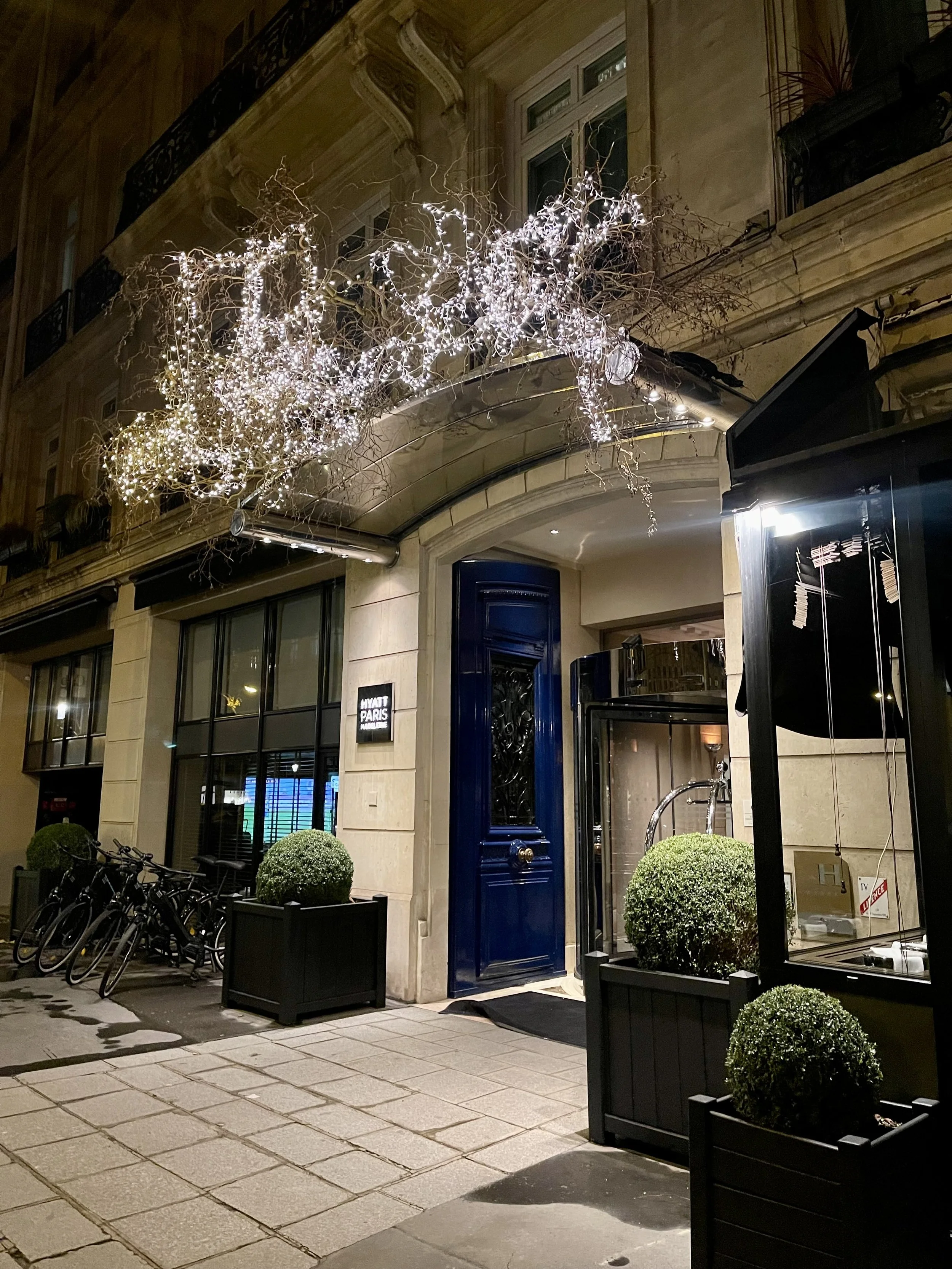 External view of hotel with blue doors and white facade