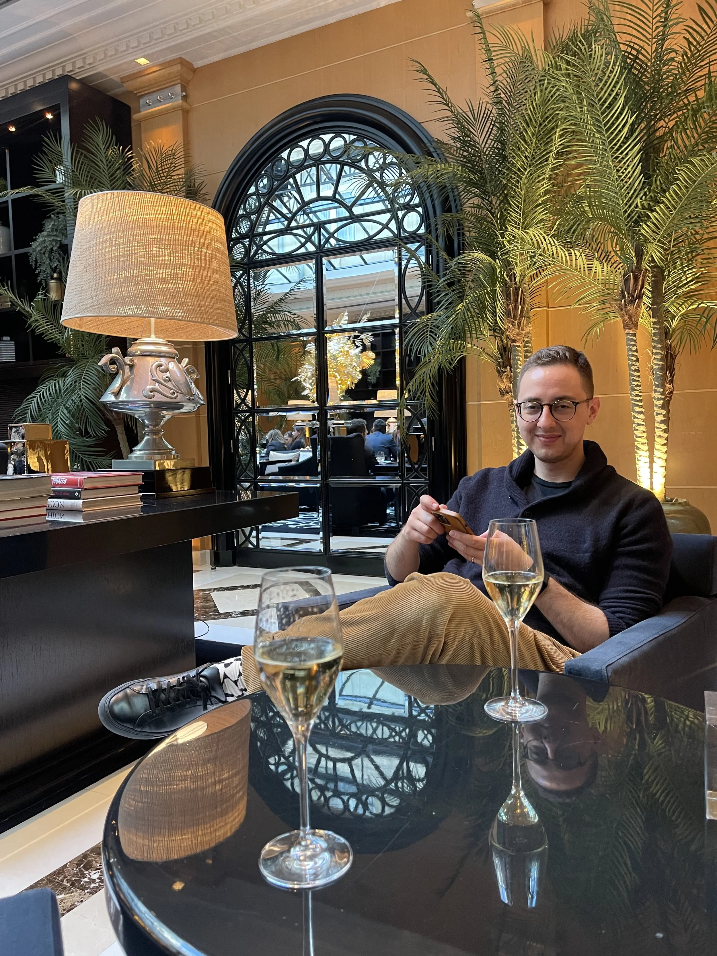 Man sitting in hotel lobby enjoying glass of champange